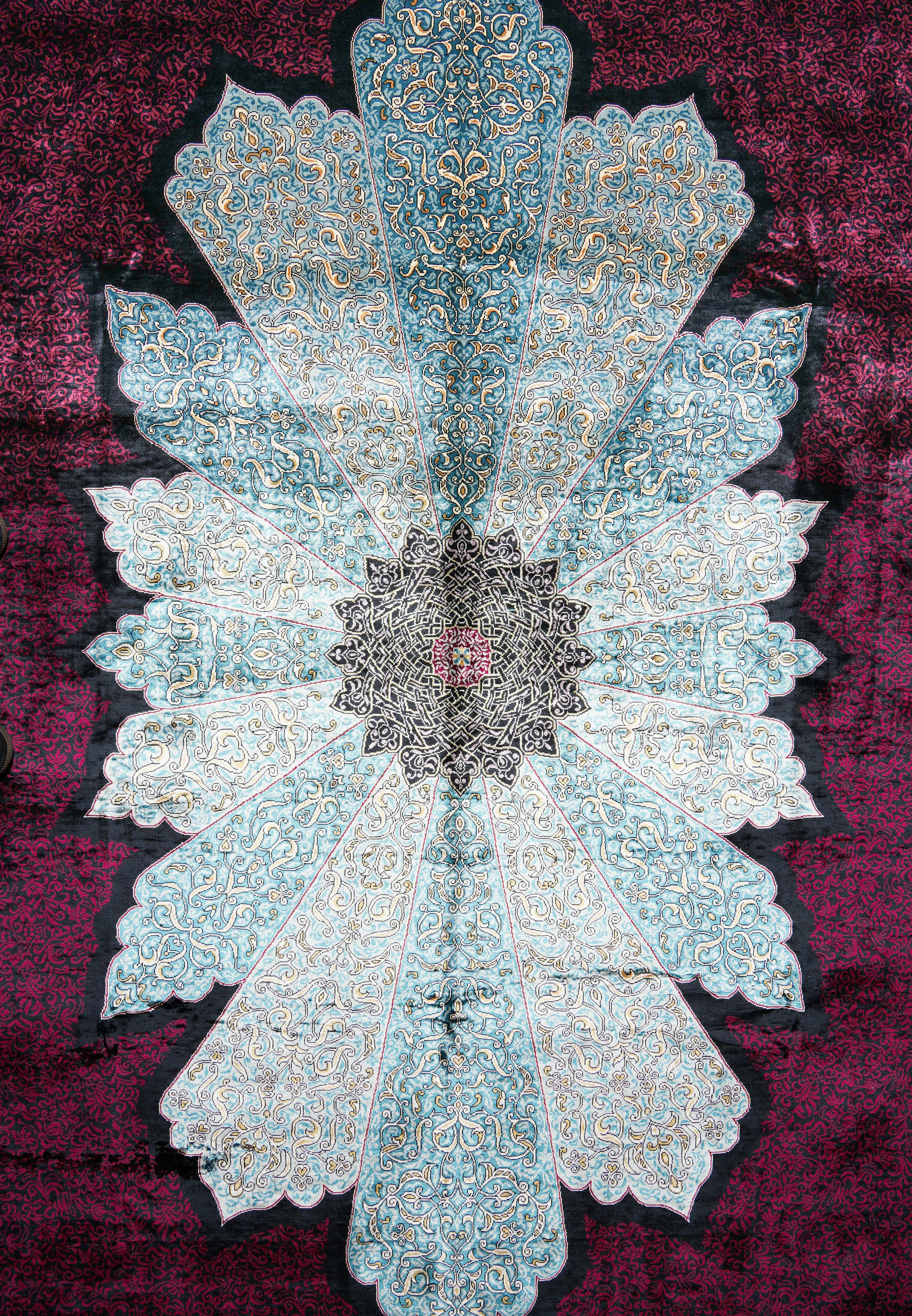 Close-up of central floral medallion on 6x9’5 Chinese silk oriental rug with sky-blue and ivory tones