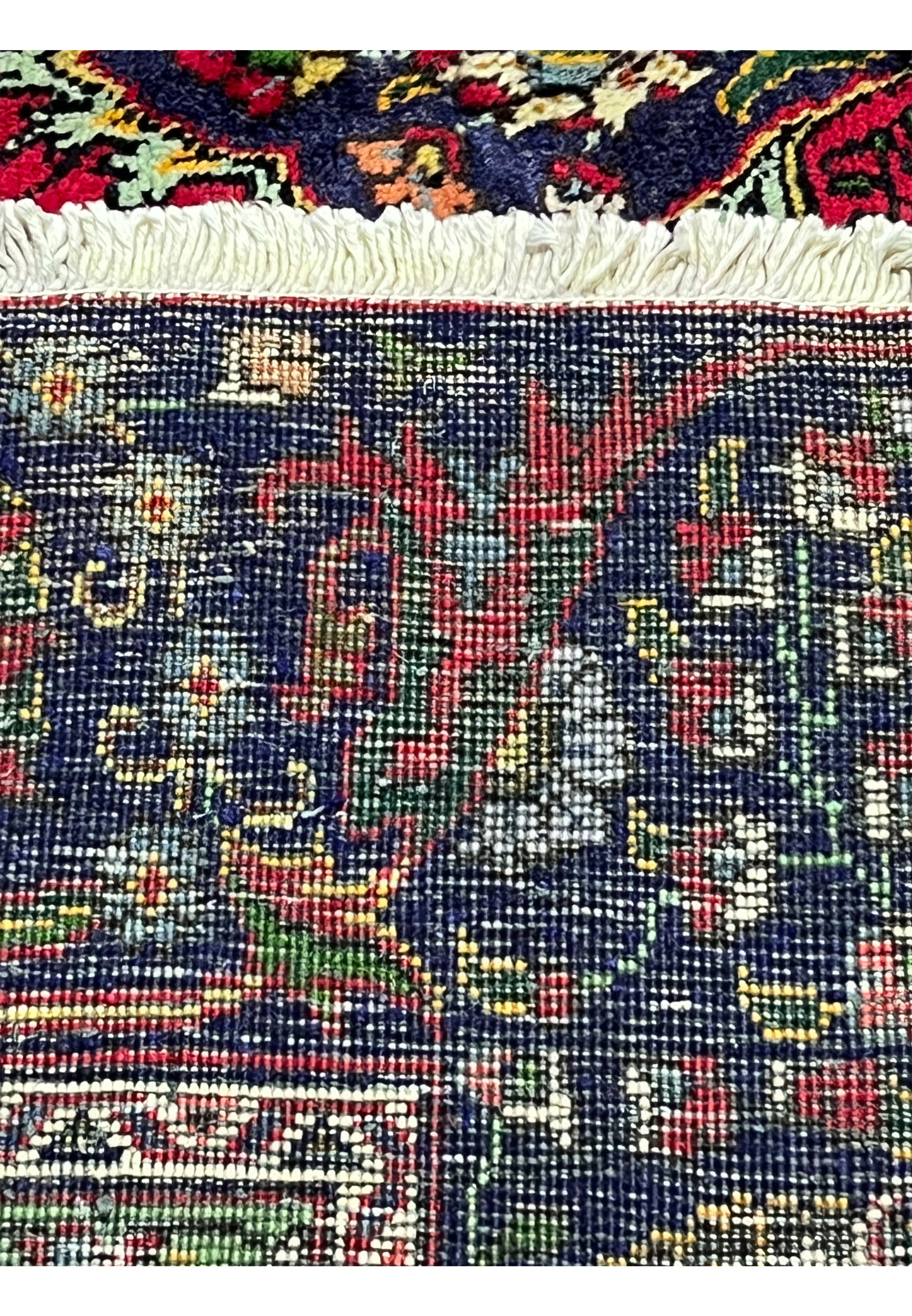 Backside of hand-knotted Persian Tabriz wool rug showing fine knot density and structure