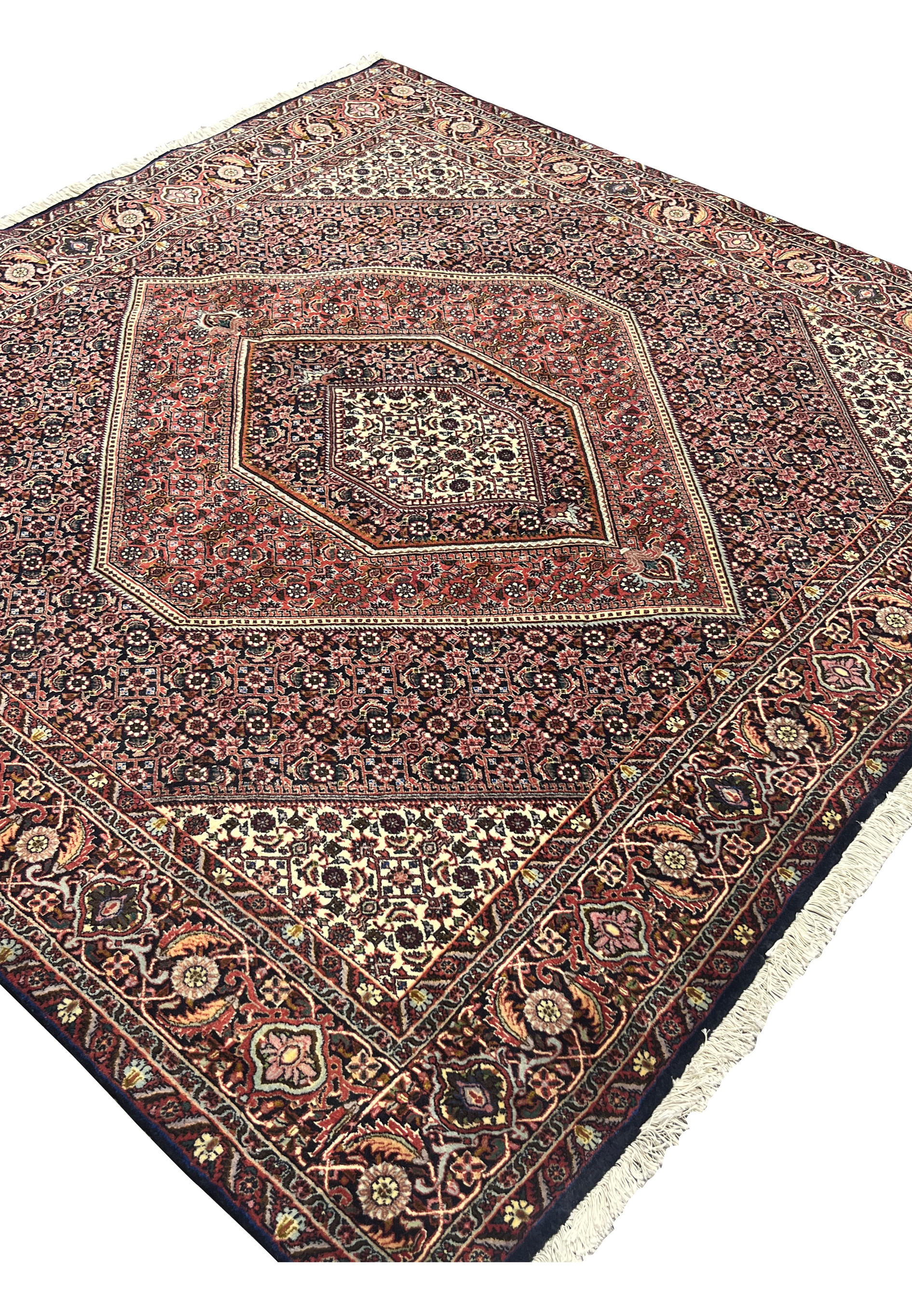 Angled view of Bijar Persian rug emphasizing its square format, layered medallion design, and luminous ivory corners framed by detailed floral borders.