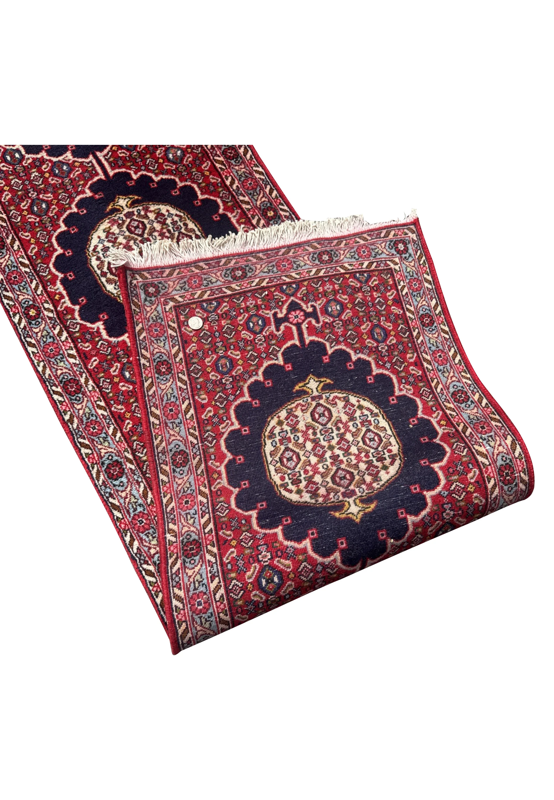 Back of hand-knotted Persian Bijar runner showing dense wool weave, red and navy pattern visible through cotton foundation.