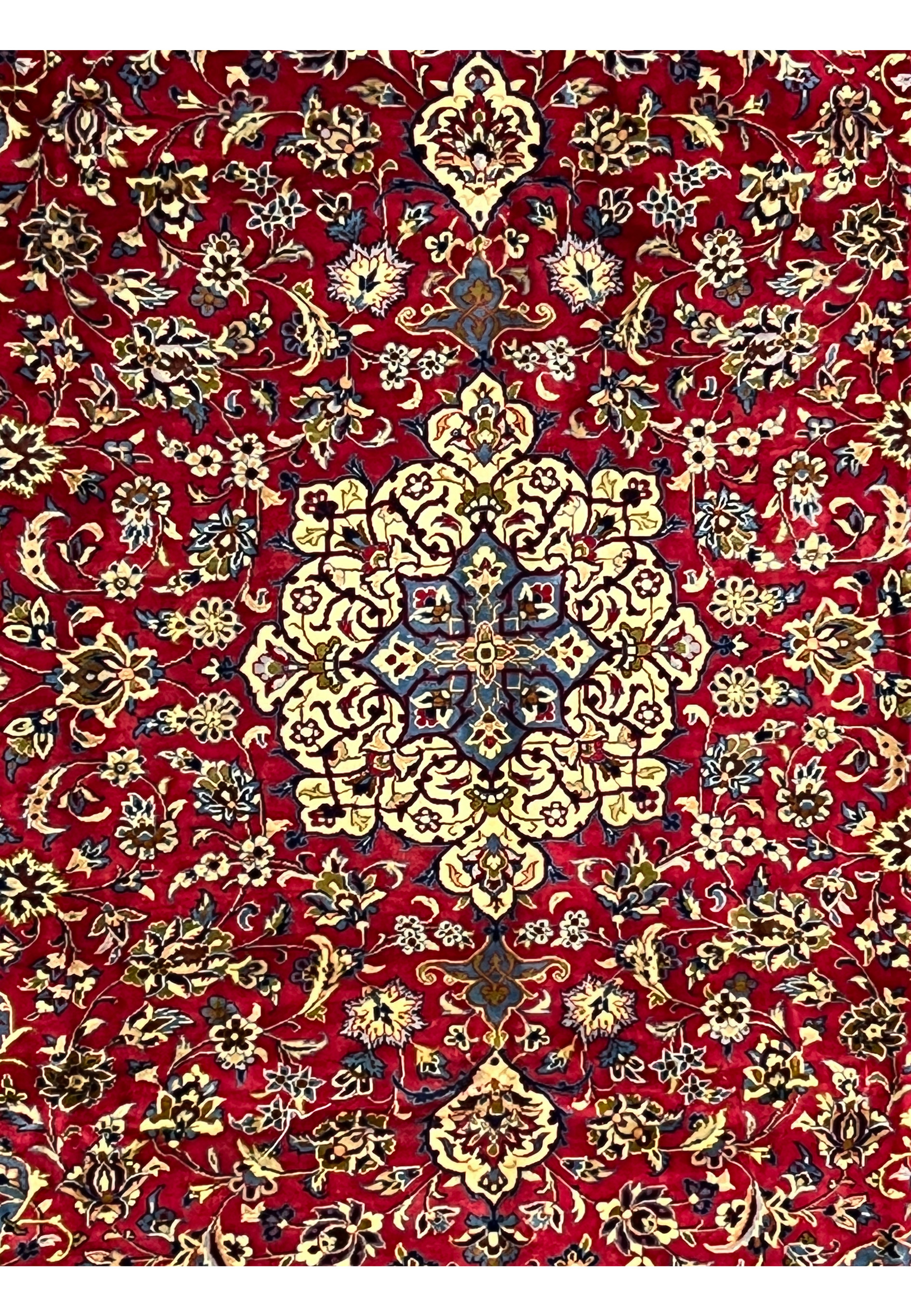 Closeup of 8'5 x 11'8 Persian Isfahan rug medallion with ivory, blue, and gold floral detailing.