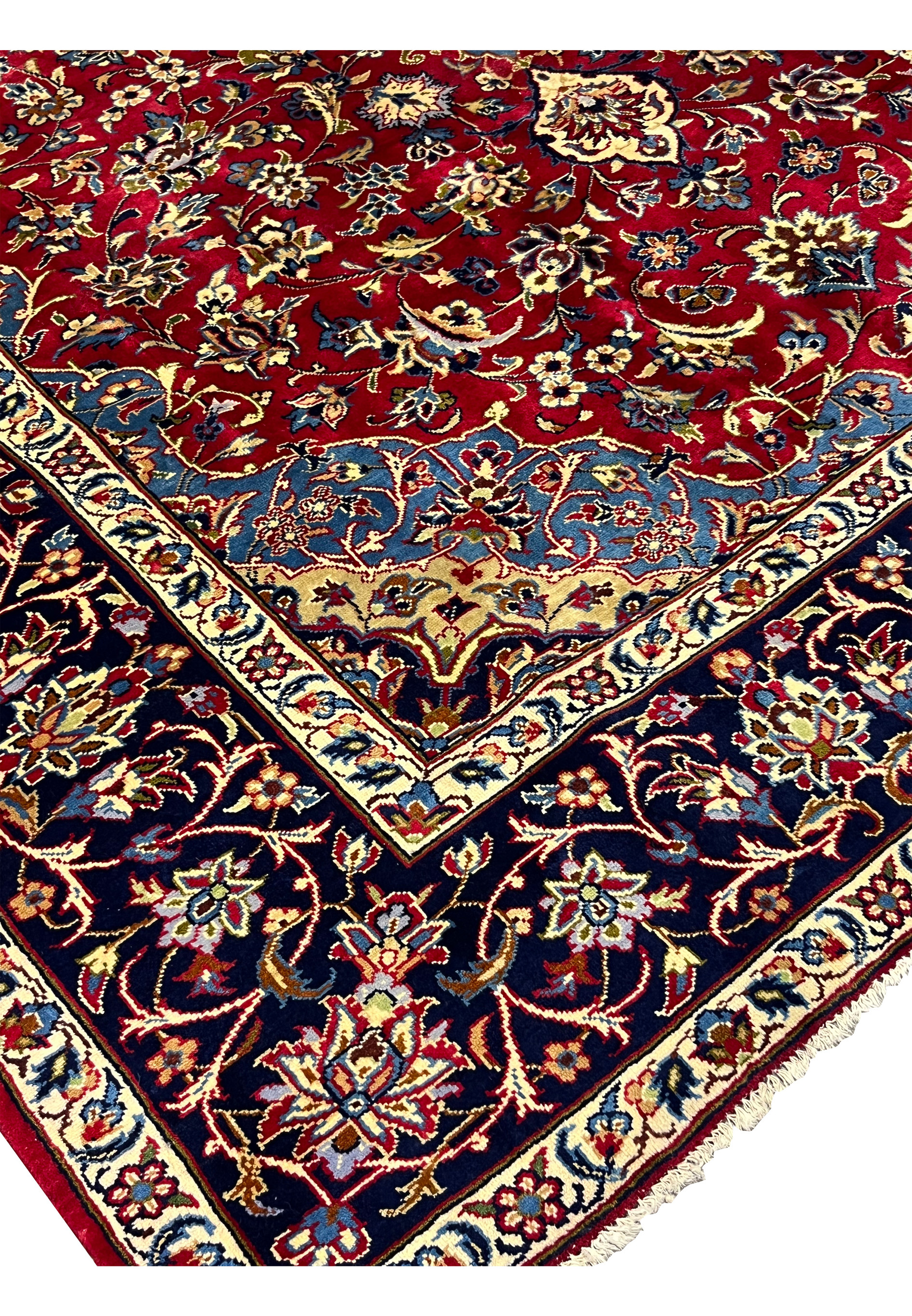 Inner border of 8'5 x 11'8 Persian Isfahan rug with scrolling floral vines and ivory outlines.