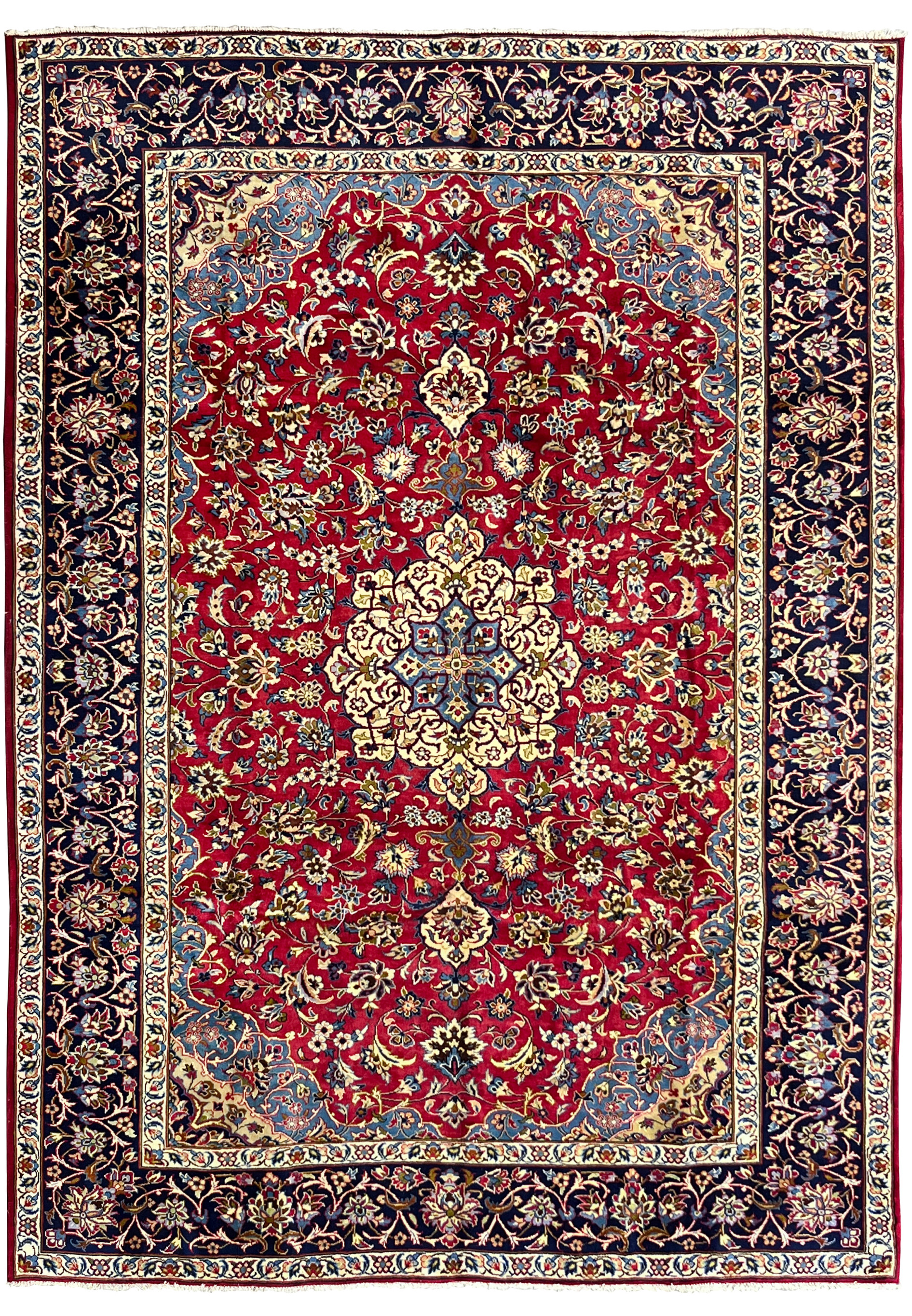 Full view of 8'5 x 11'8 Persian Isfahan rug showing red wool field, ivory medallion, and navy floral border.