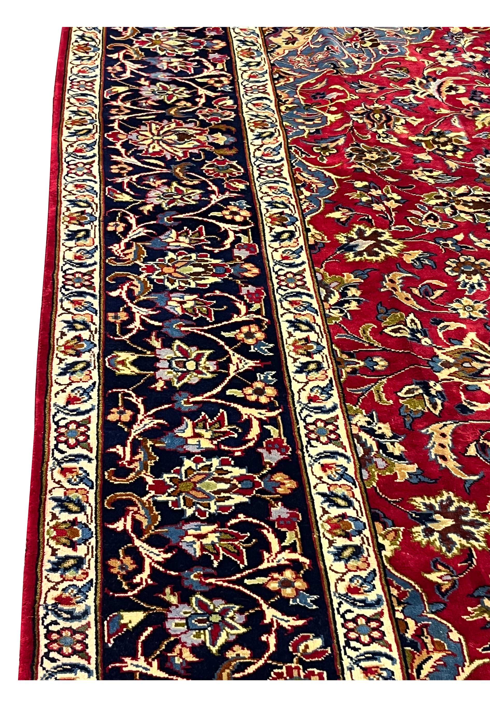 Side border of 8'5 x 11'8 Persian Isfahan rug showing navy floral vines and ivory guard stripes.
