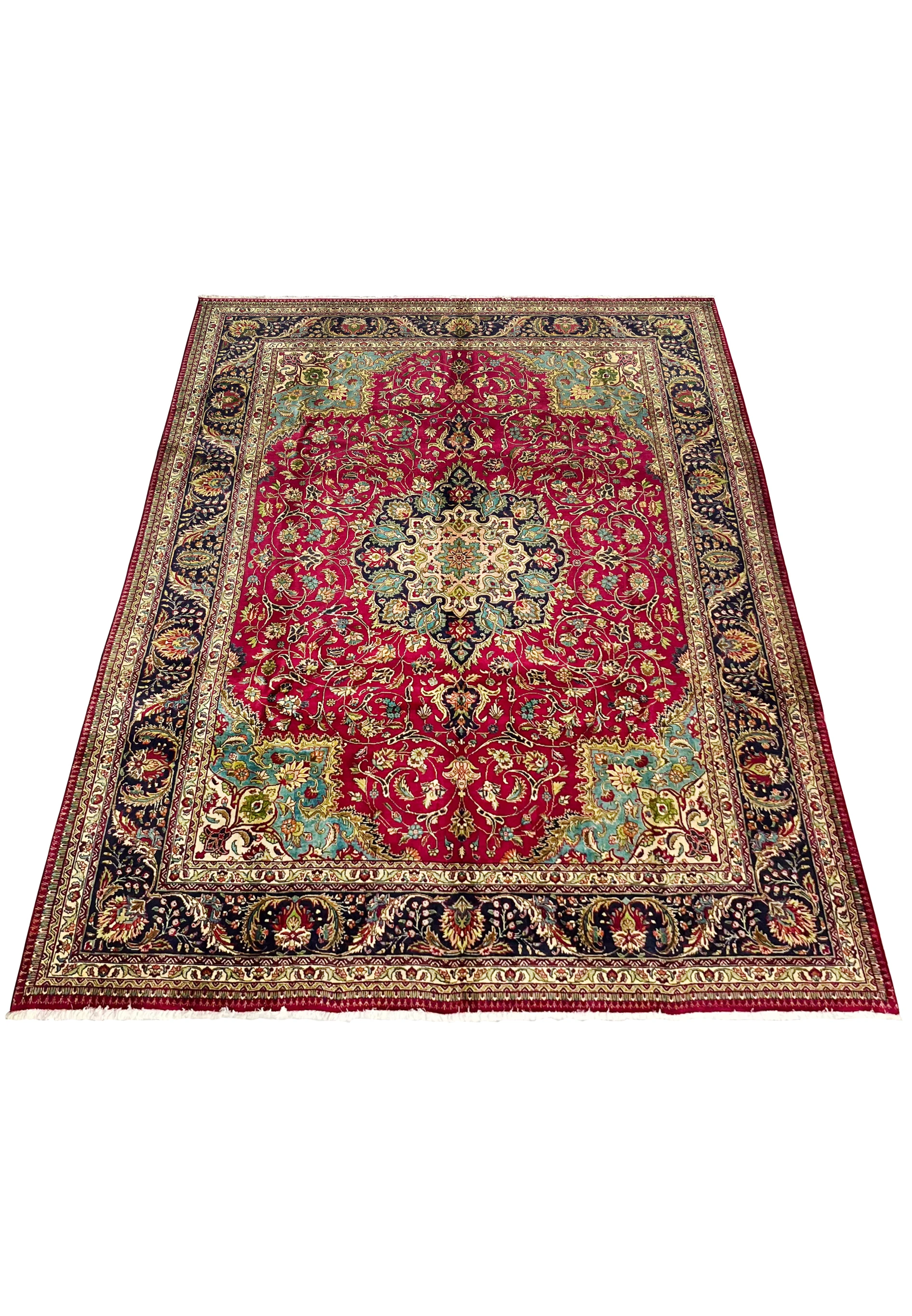 lower section of Persian Tabriz rug showing floral layout, rich red field, and multi-toned corner design