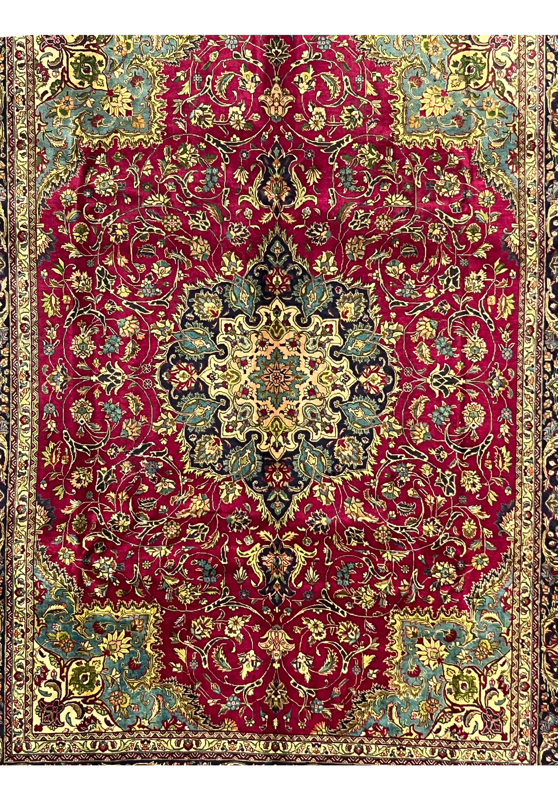 detailed midfield of 9'9 x 12'4 Persian Tabriz rug showing dense floral vines on deep wine red background