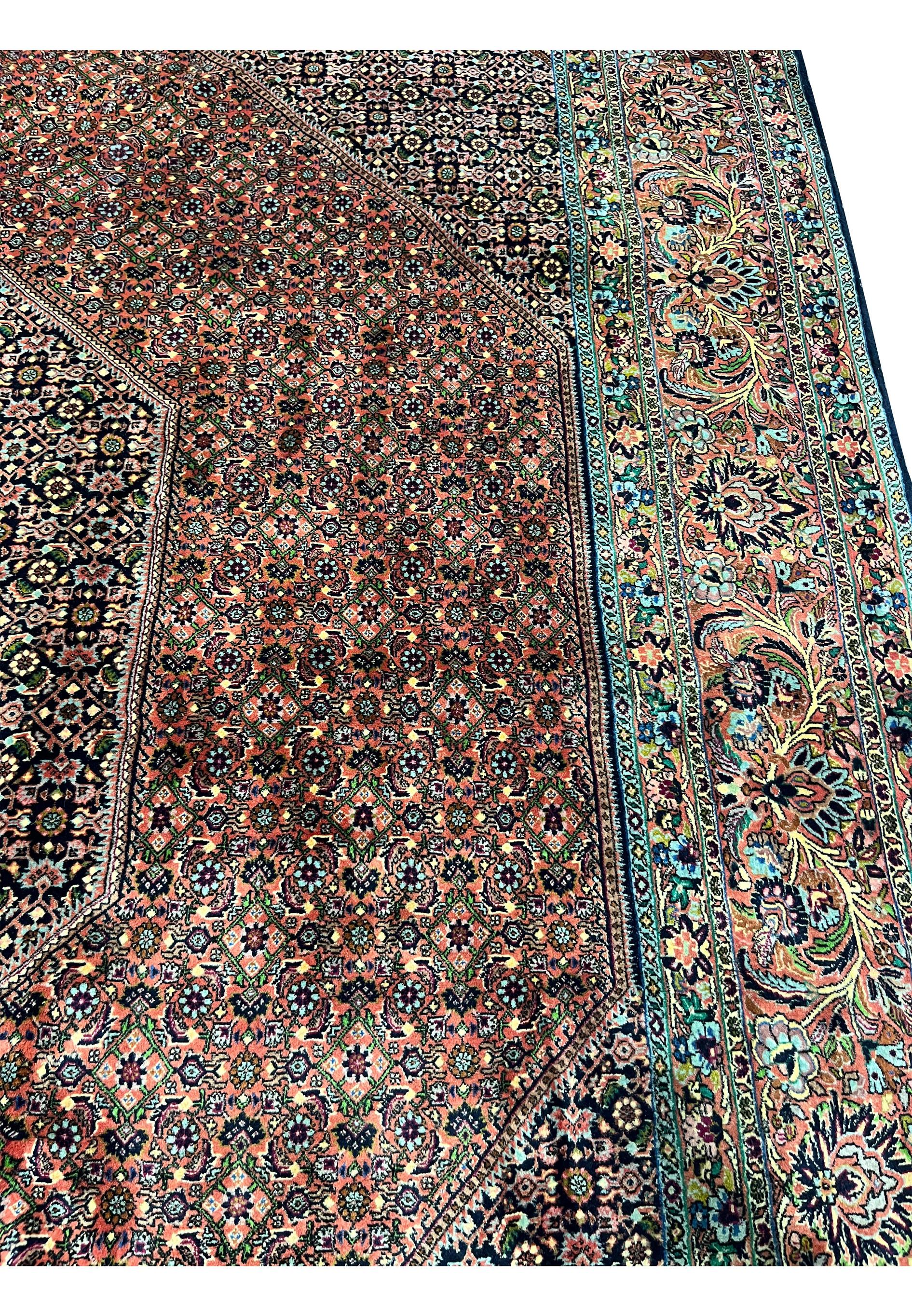 Side view of 10x13’5 Persian Bijar rug showing brick red field, geometric layers, and detailed floral border work.