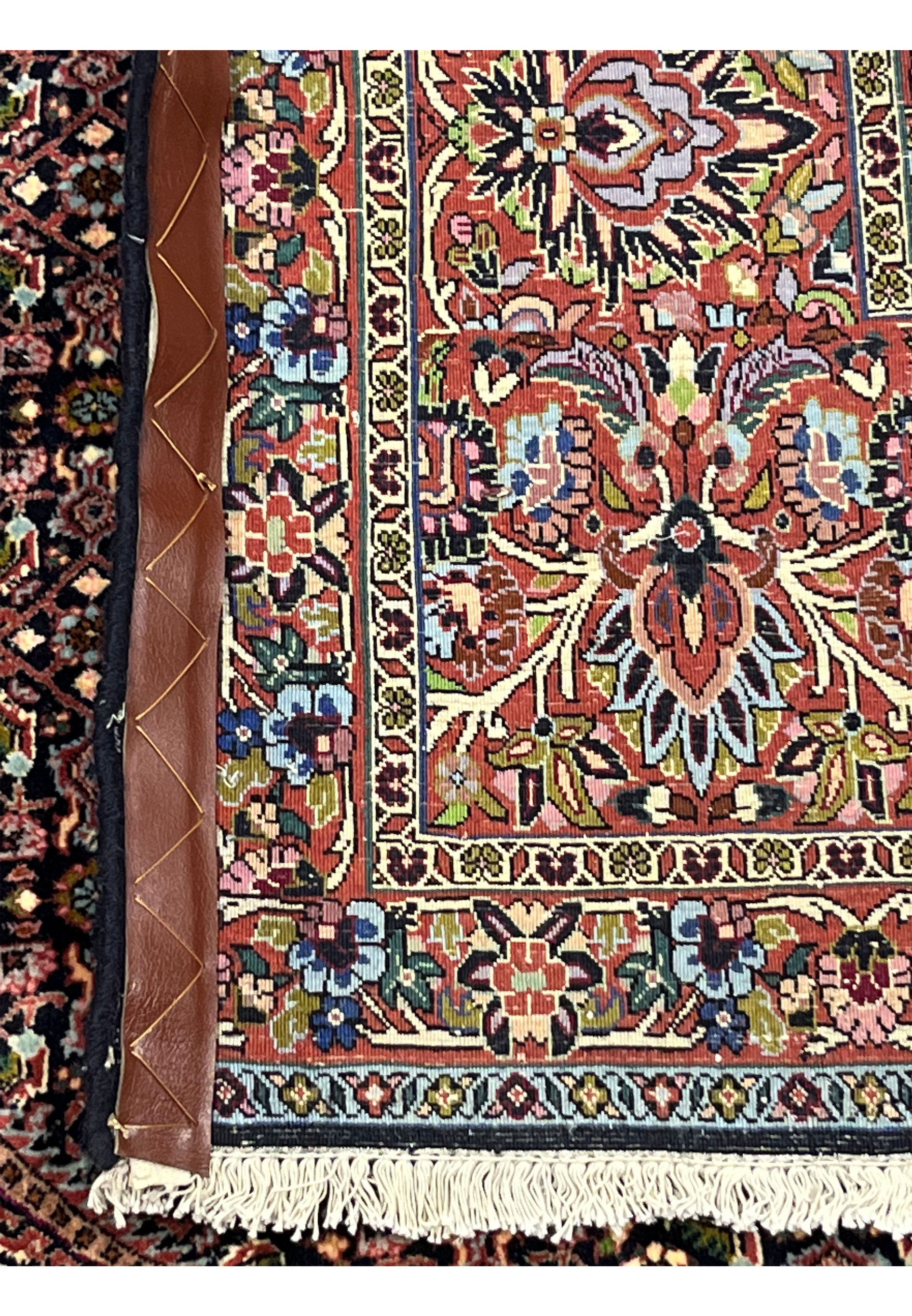Reverse side of the Persian Bijar rug displaying border florals, geometric motifs, and sturdy wool foundation.