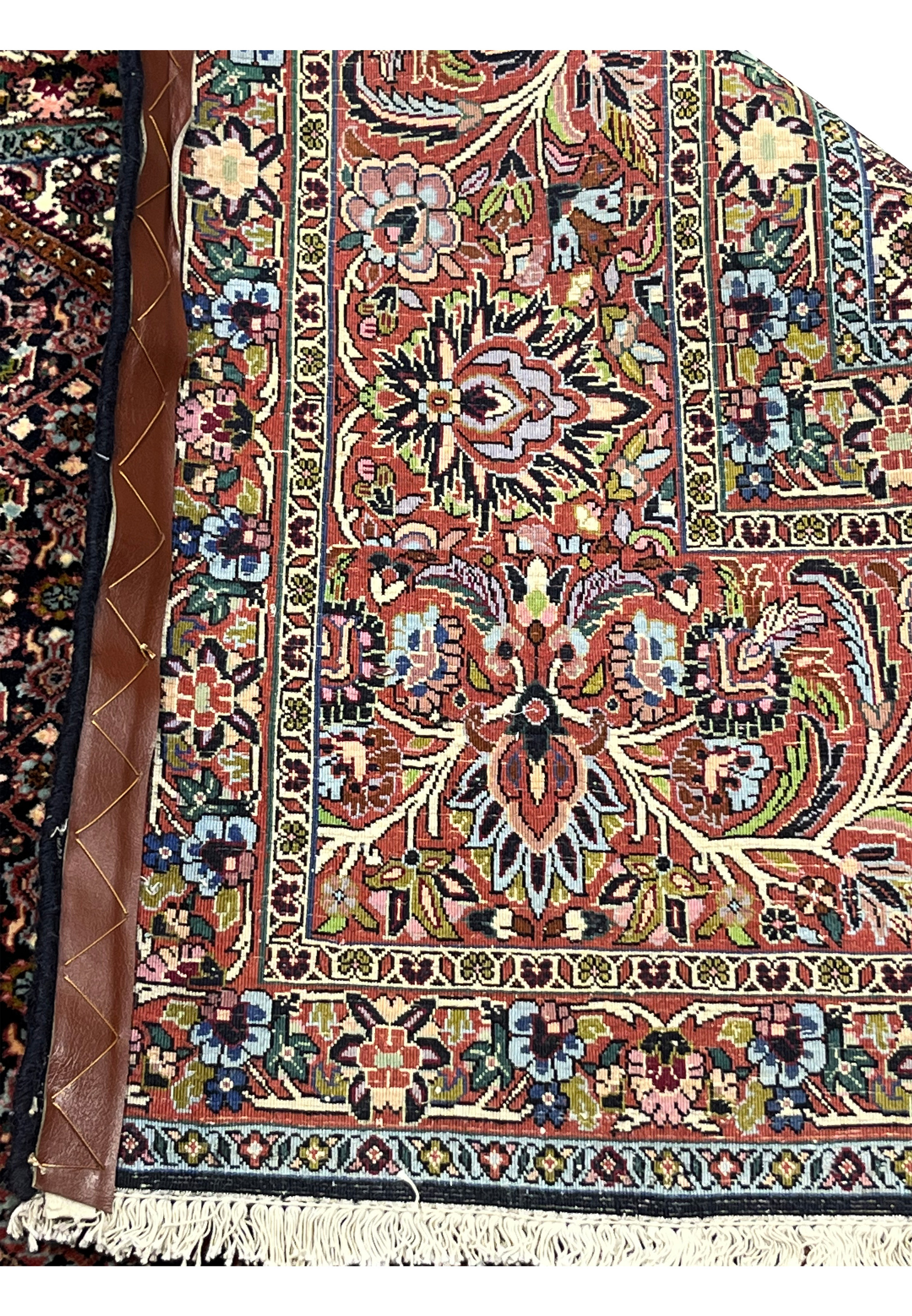 Backside view of the Bijar rug showing finely knotted wool foundation and crisp floral border design.