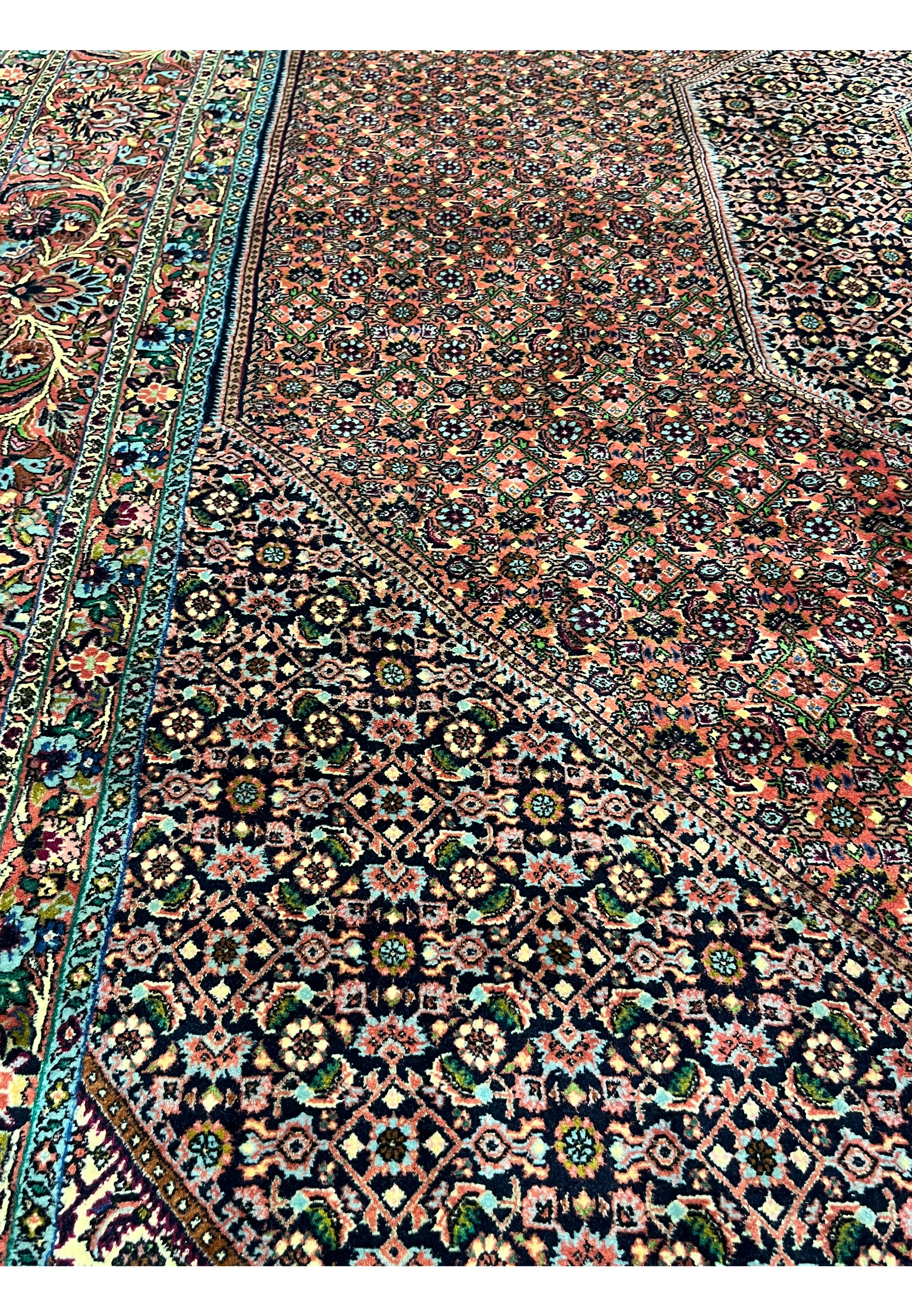 Close-up of Bijar rug field pattern with repeating rosettes, diamonds, and navy lattice outlines