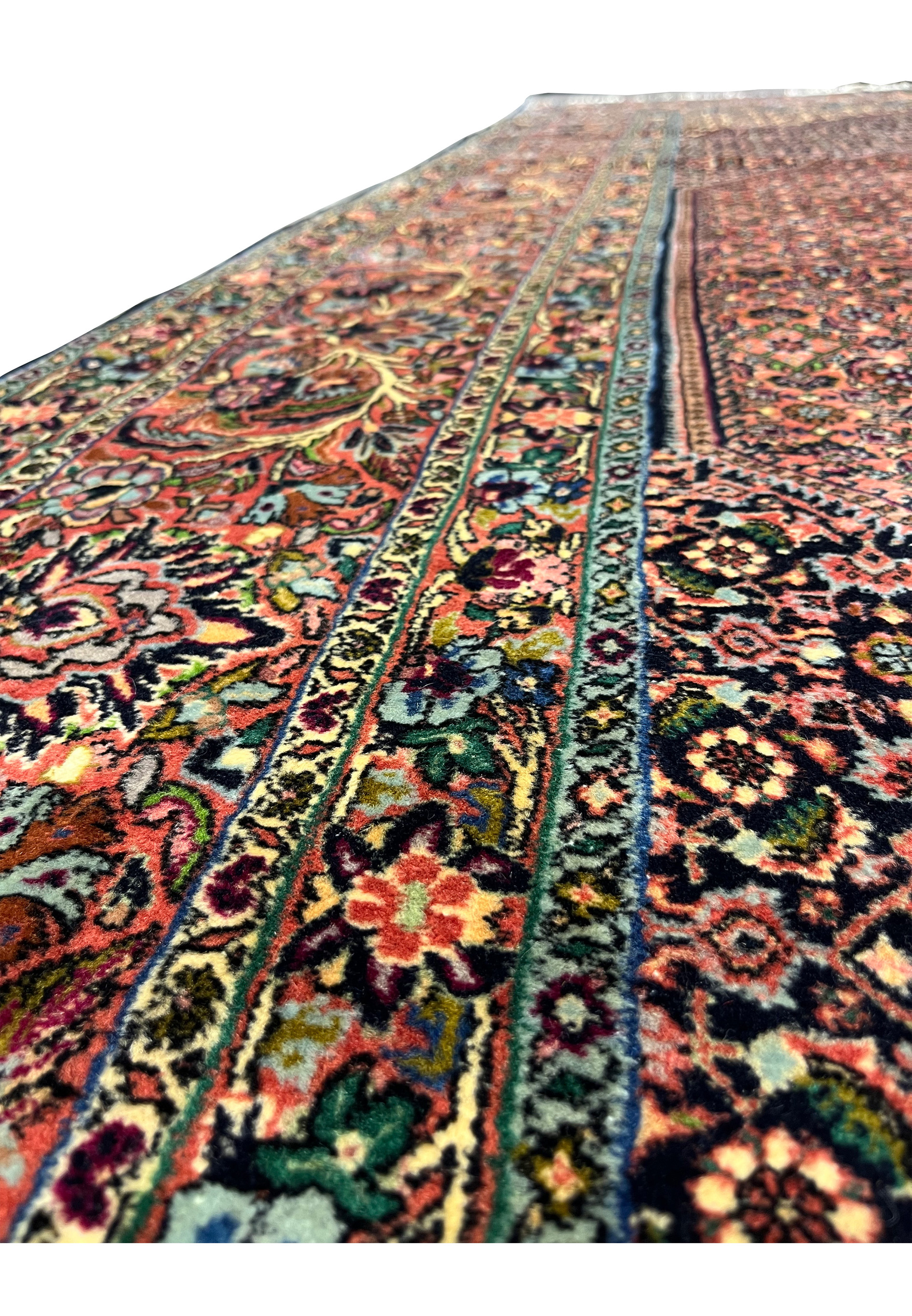 Color detail of Bijar rug showing brick red field, navy outlines, green leaves, and sky blue highlights.