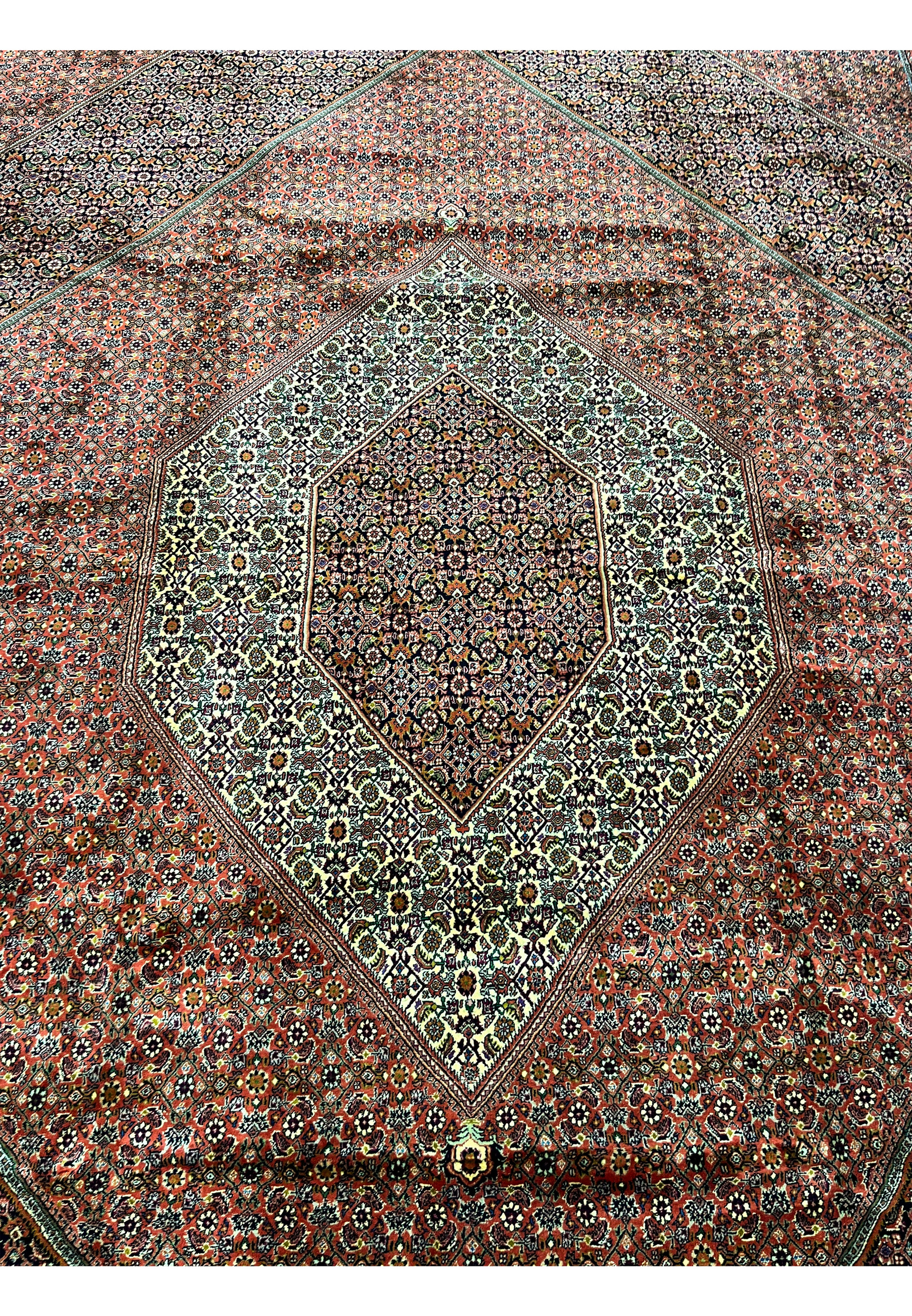 Full central medallion of the Bijar Persian Iron Rug with cream and navy floral latticework.