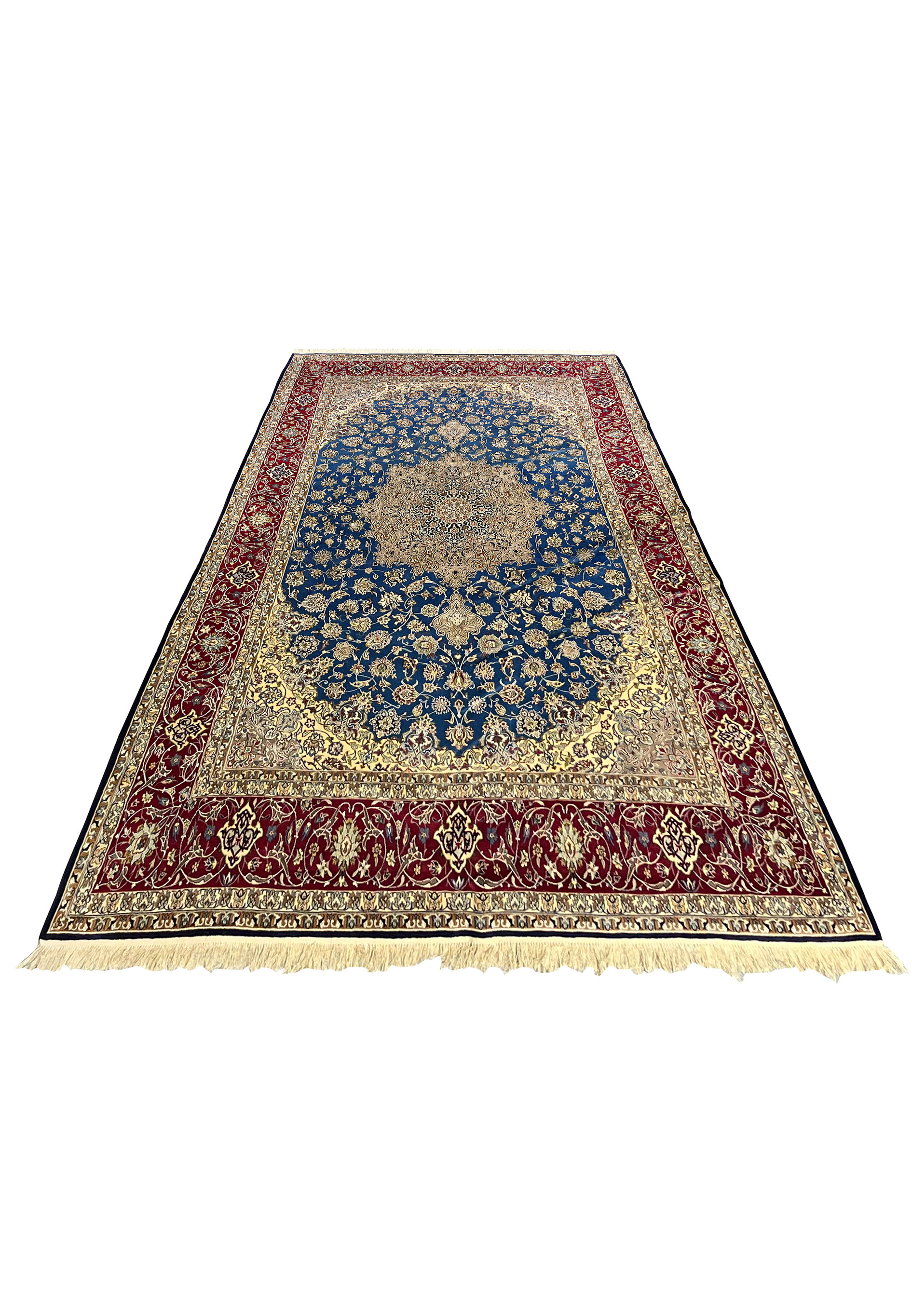 Full top view of a 6'9 x 11'2 Persian Isfahan rug with a blue field, ivory medallion, and rich red borders woven in wool and silk.