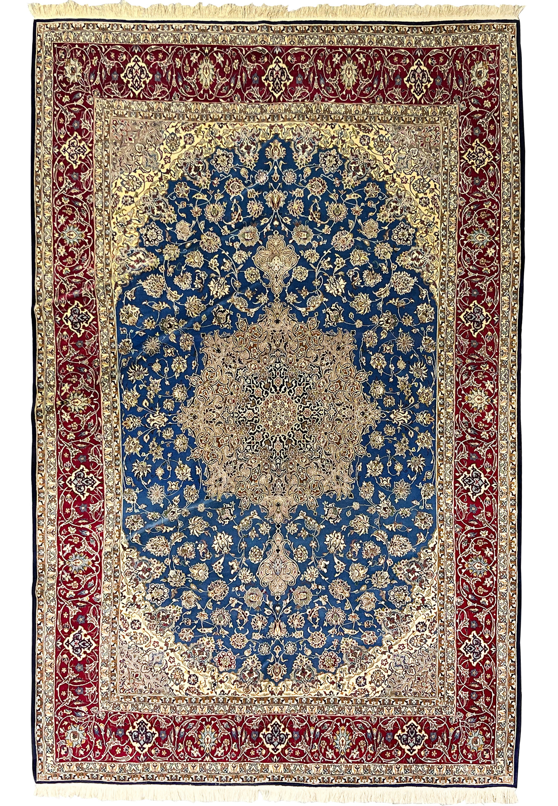 Complete overhead view showing the blue floral field, ornate central medallion, and deep red borders of this Persian Isfahan wool and silk rug.