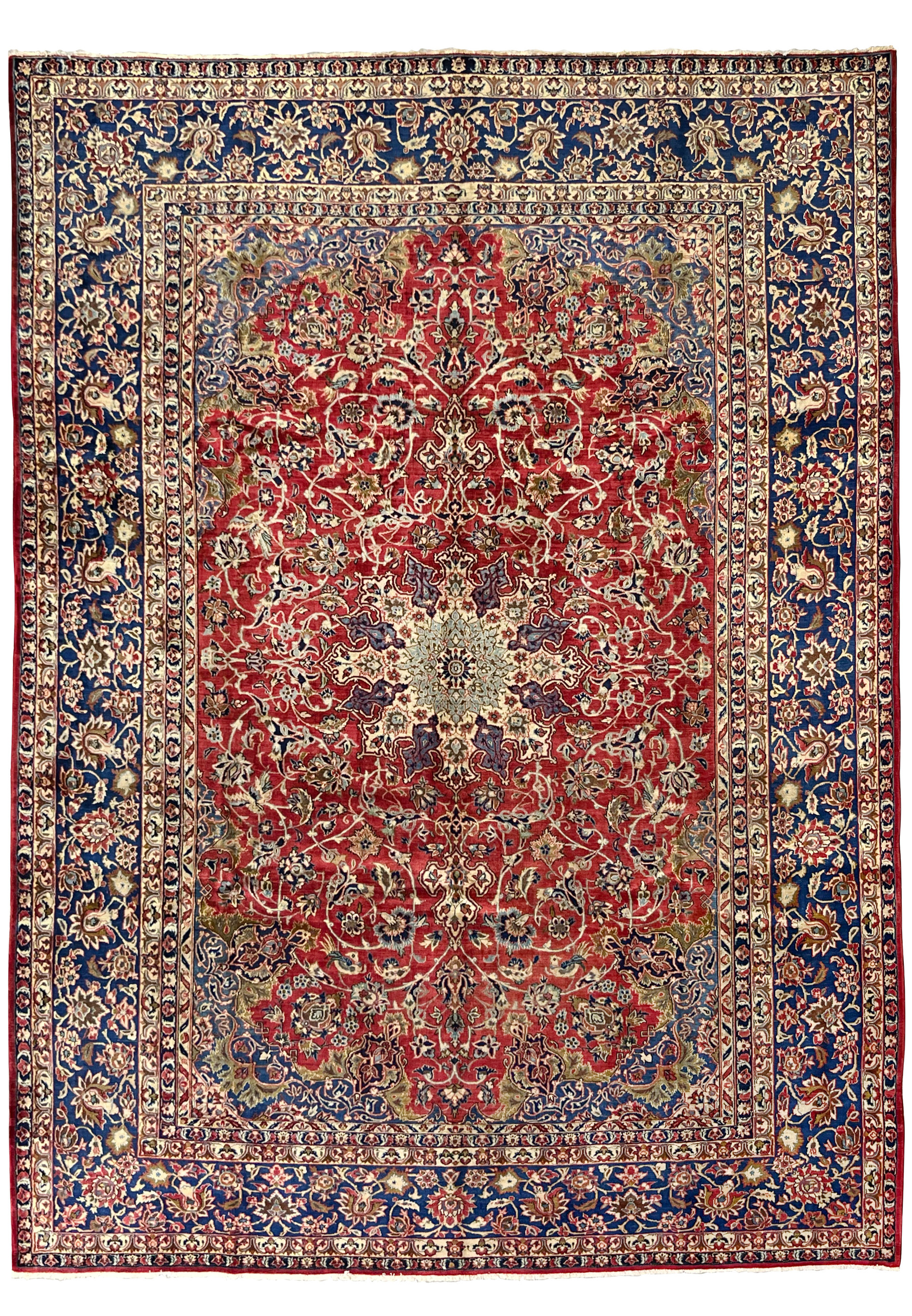 Full view of the 9'9 x 14'5 vintage Najafabad Persian rug featuring a large medallion, ruby red field, and navy floral borders.
