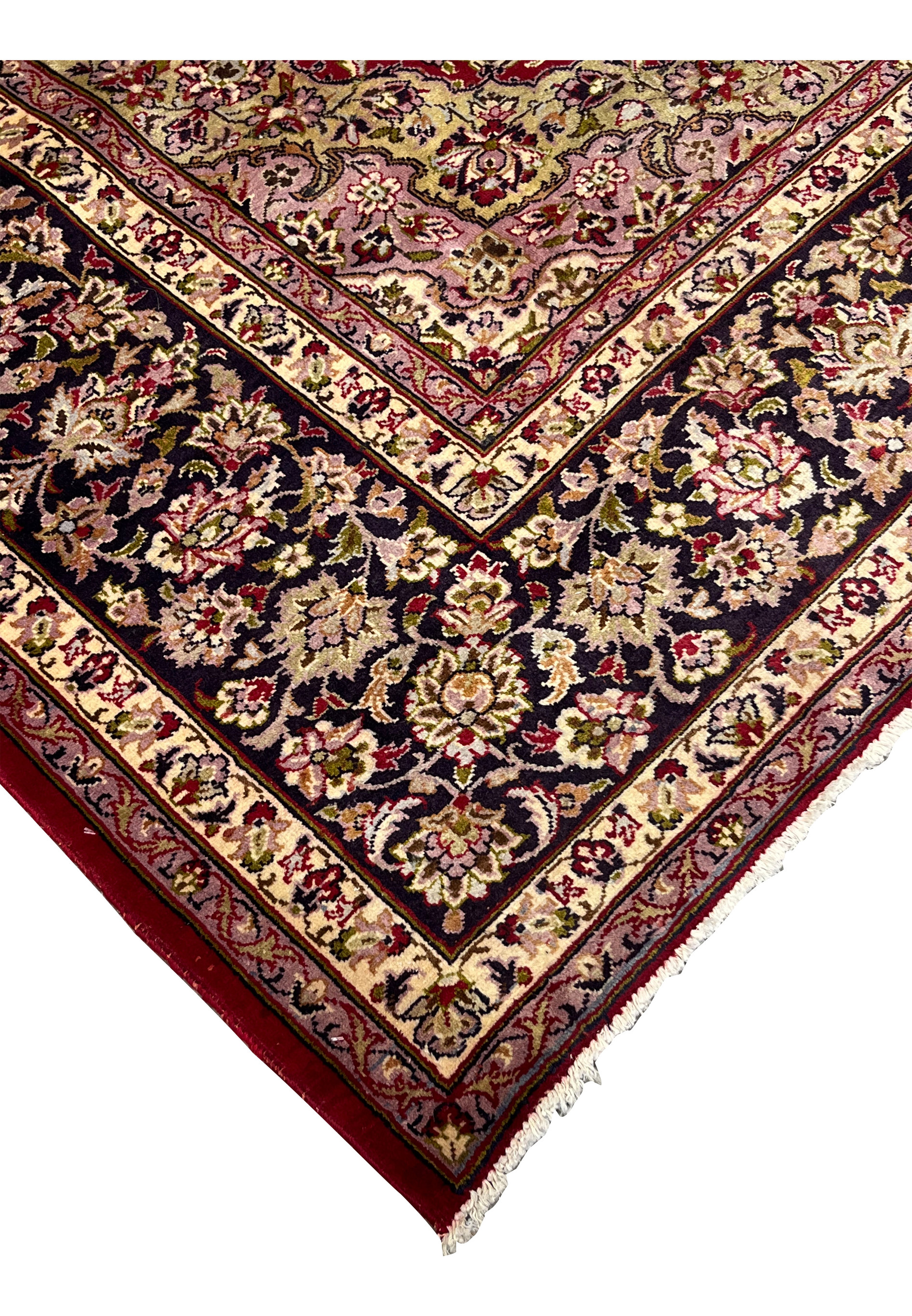 Corner and edge detail of Persian Isfahan rug with cream and navy floral border