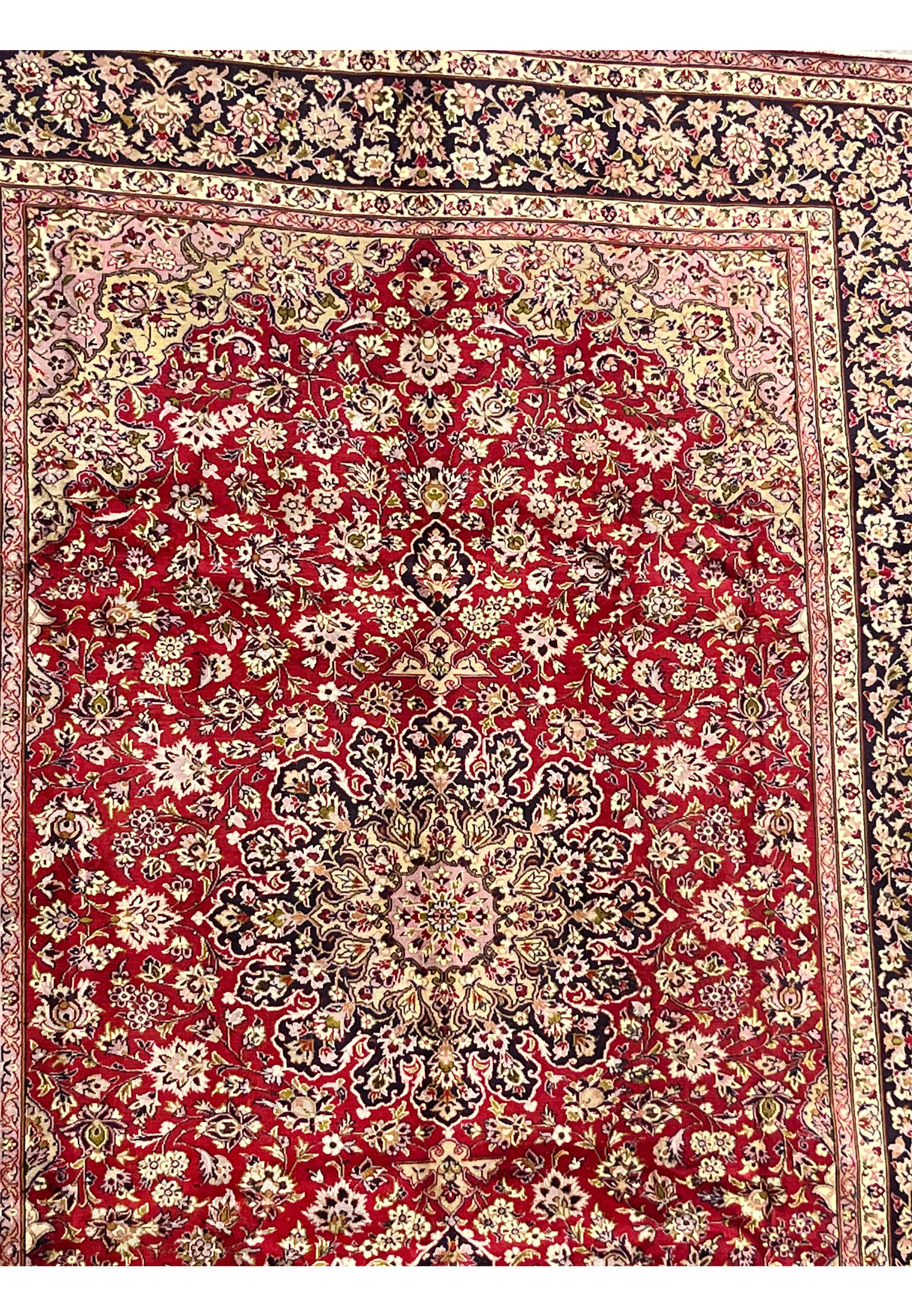 Upper section of red Isfahan rug with fine floral patterns and curved medallion details