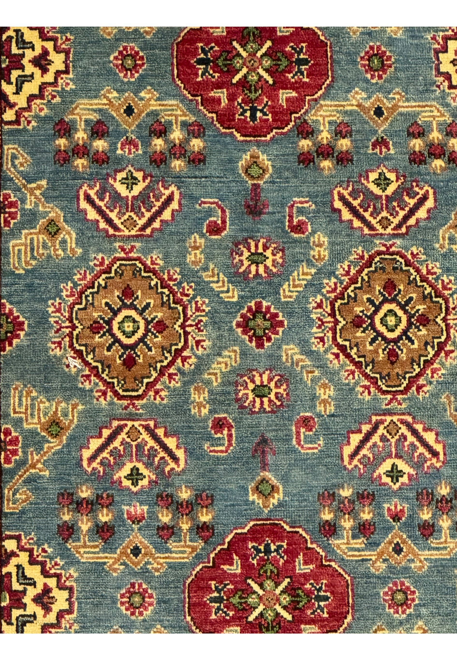 Pattern closeup highlighting medallions and small floral-tribal motifs.