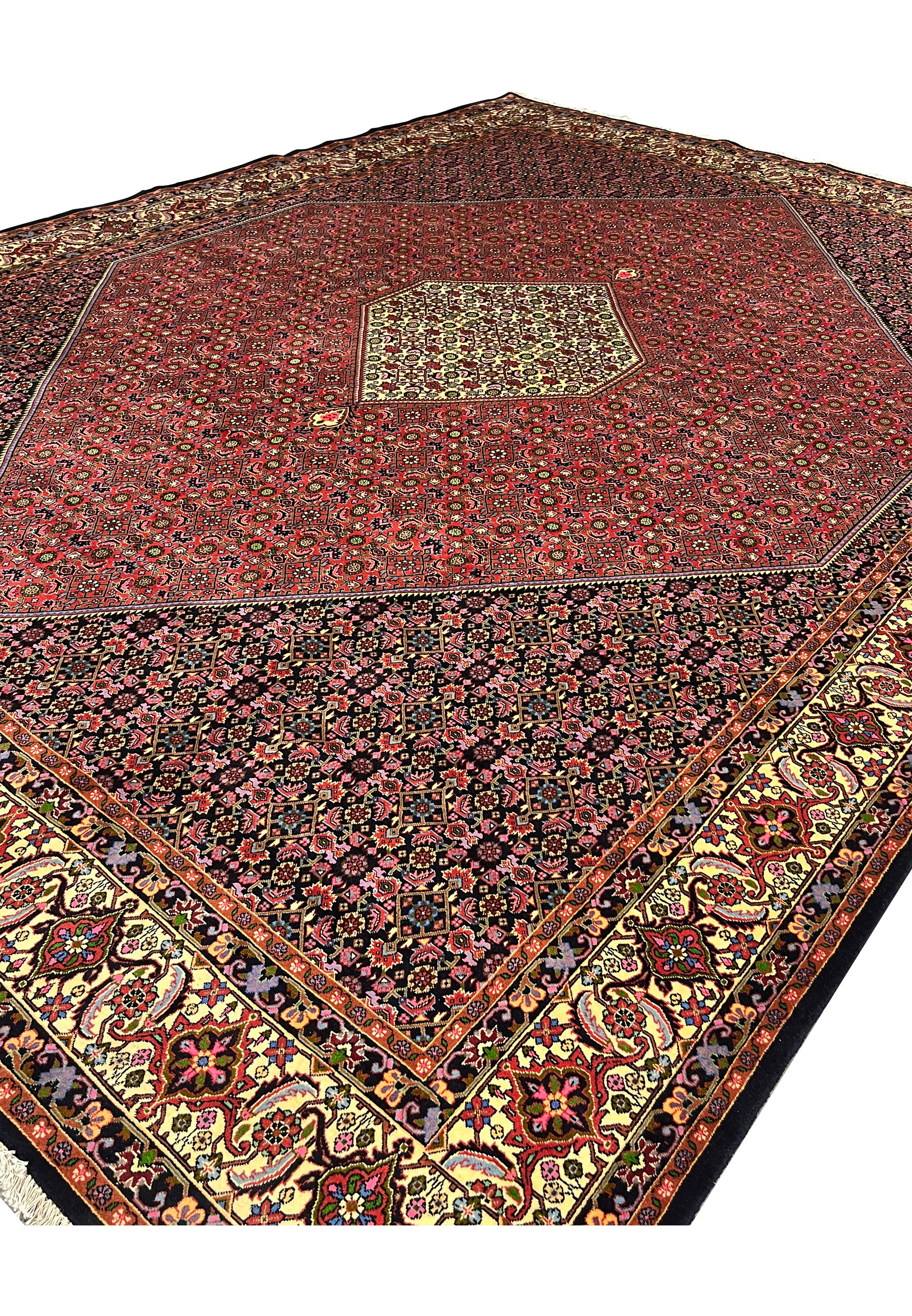 Angled perspective of rare size Persian Bijar iron rug emphasizing heavy wool structure, deep saturation, and architectural medallion layout