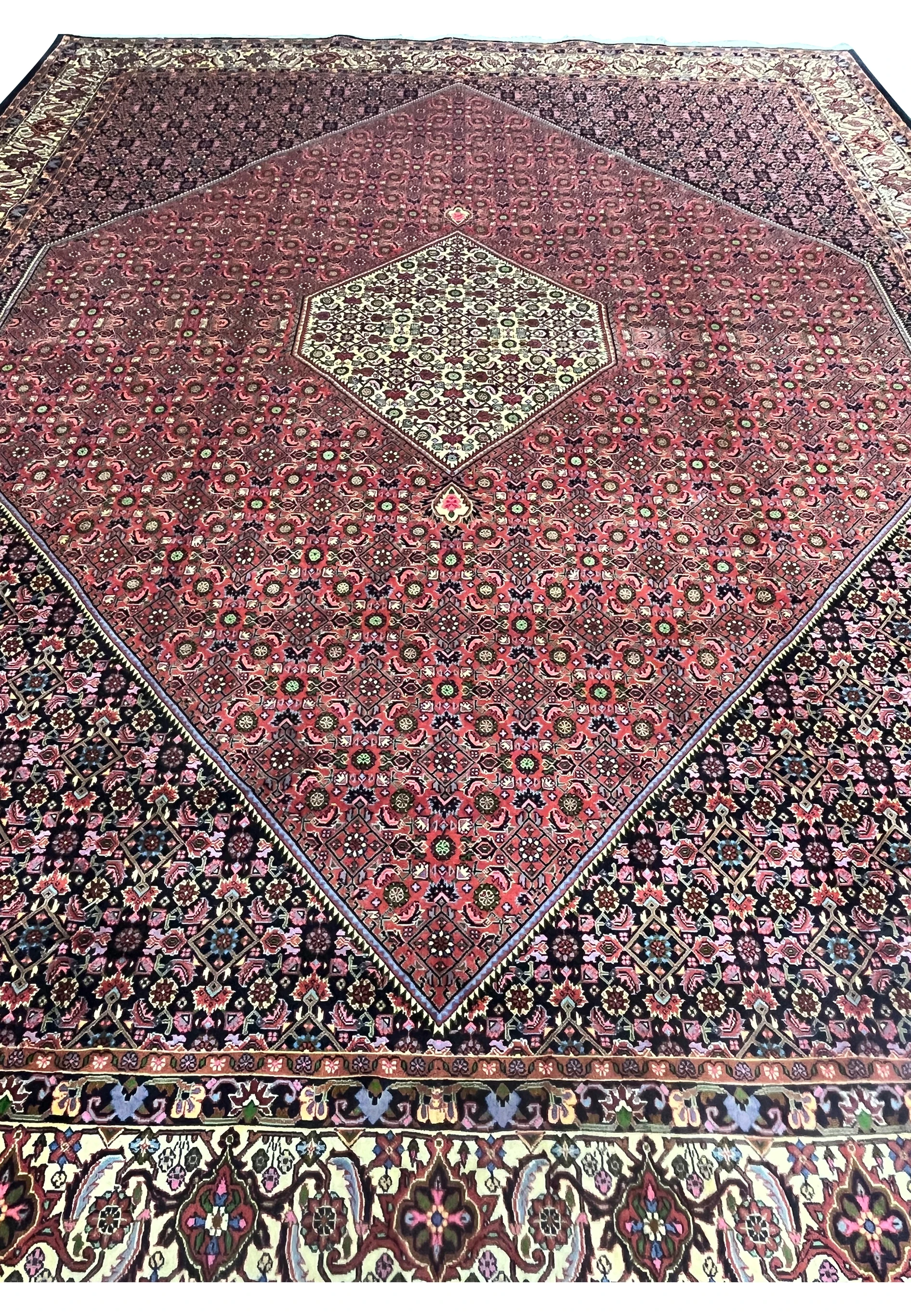 Top view of Persian Bijar iron rug highlighting compact knotting, high density wool construction, and intricate repeating floral lattice