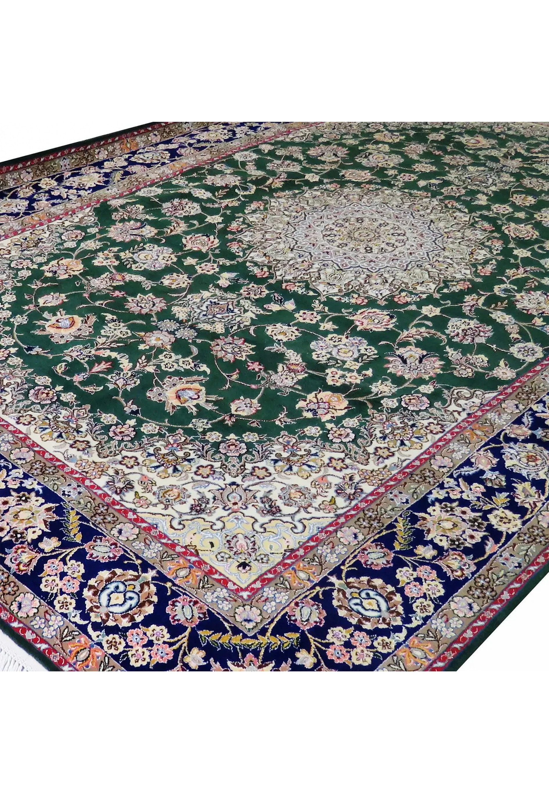 Angled view of 7x10 deep green Persian Nain 9LA rug showing navy border, ivory corner spandrels, and detailed floral vine pattern