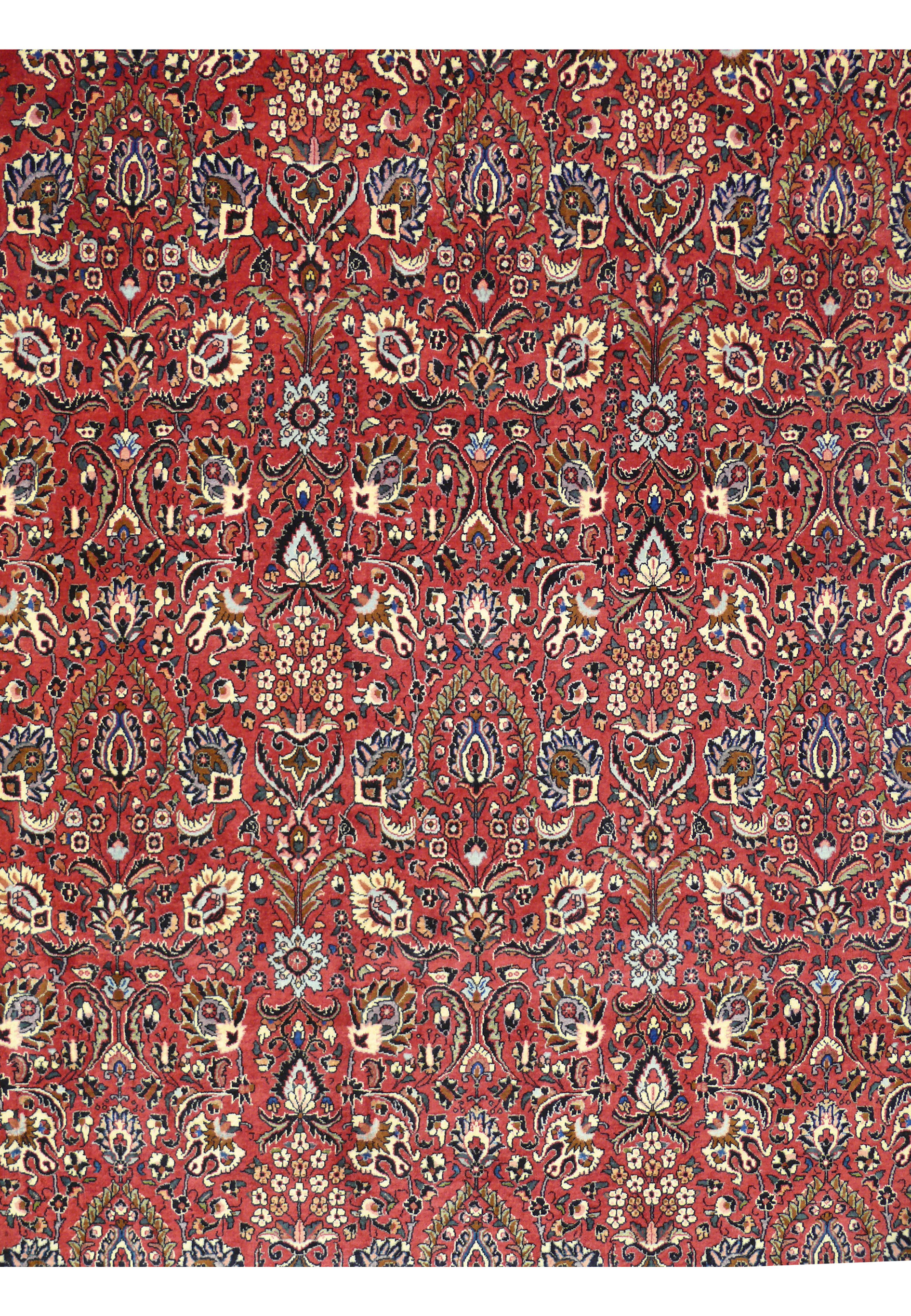 Detailed border of a 6'6 x 9'6 rare Persian Bijar iron rug with navy blue floral frame on red background