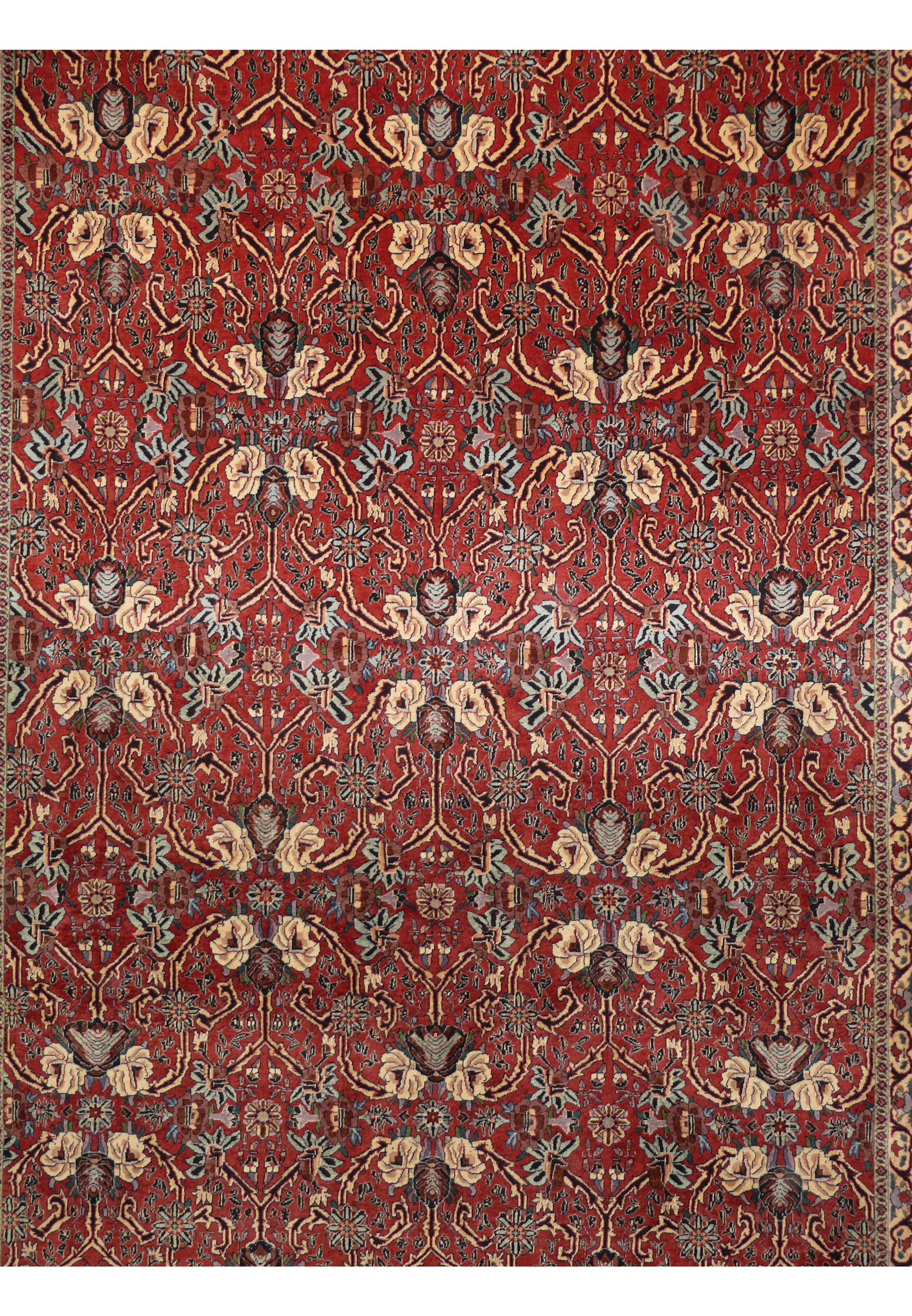 Midfield detail of floral Bijar rug with brick red field, ivory flowers, steel blue vines, navy outlines, and walnut accents