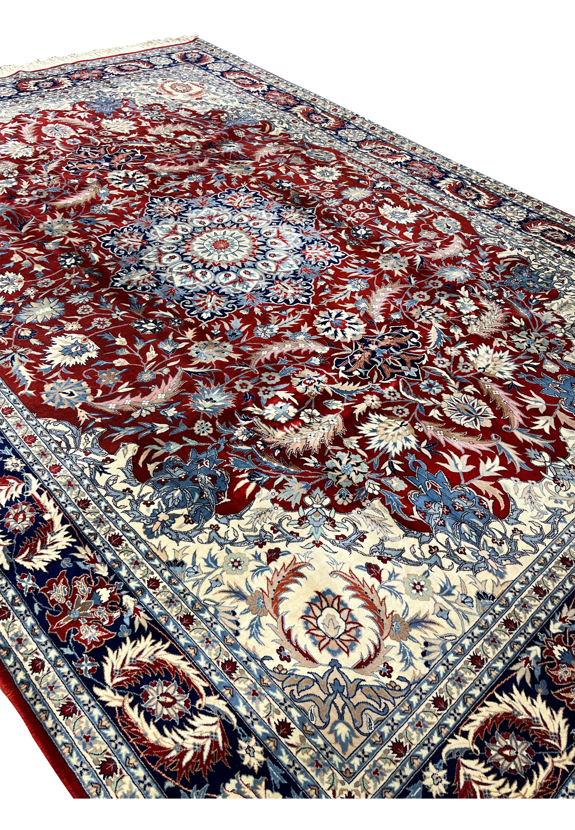 Angled view of an 8'5 x 11'8 Persian Isfahan rug showing depth of pile, crisp floral detailing, and elegant border framing