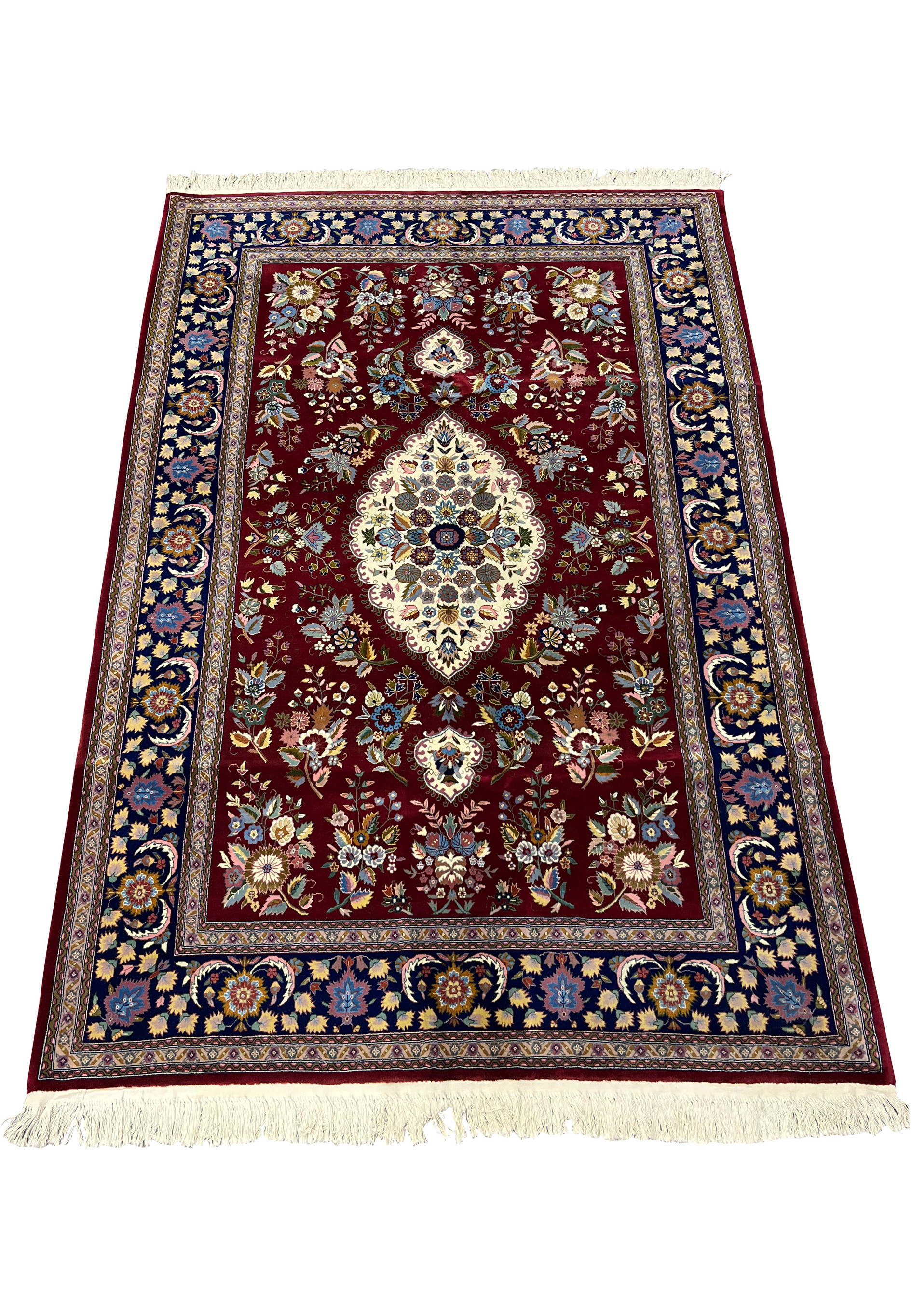 Top view of Persian Isfahan rug showing symmetrical medallion design and detailed floral field