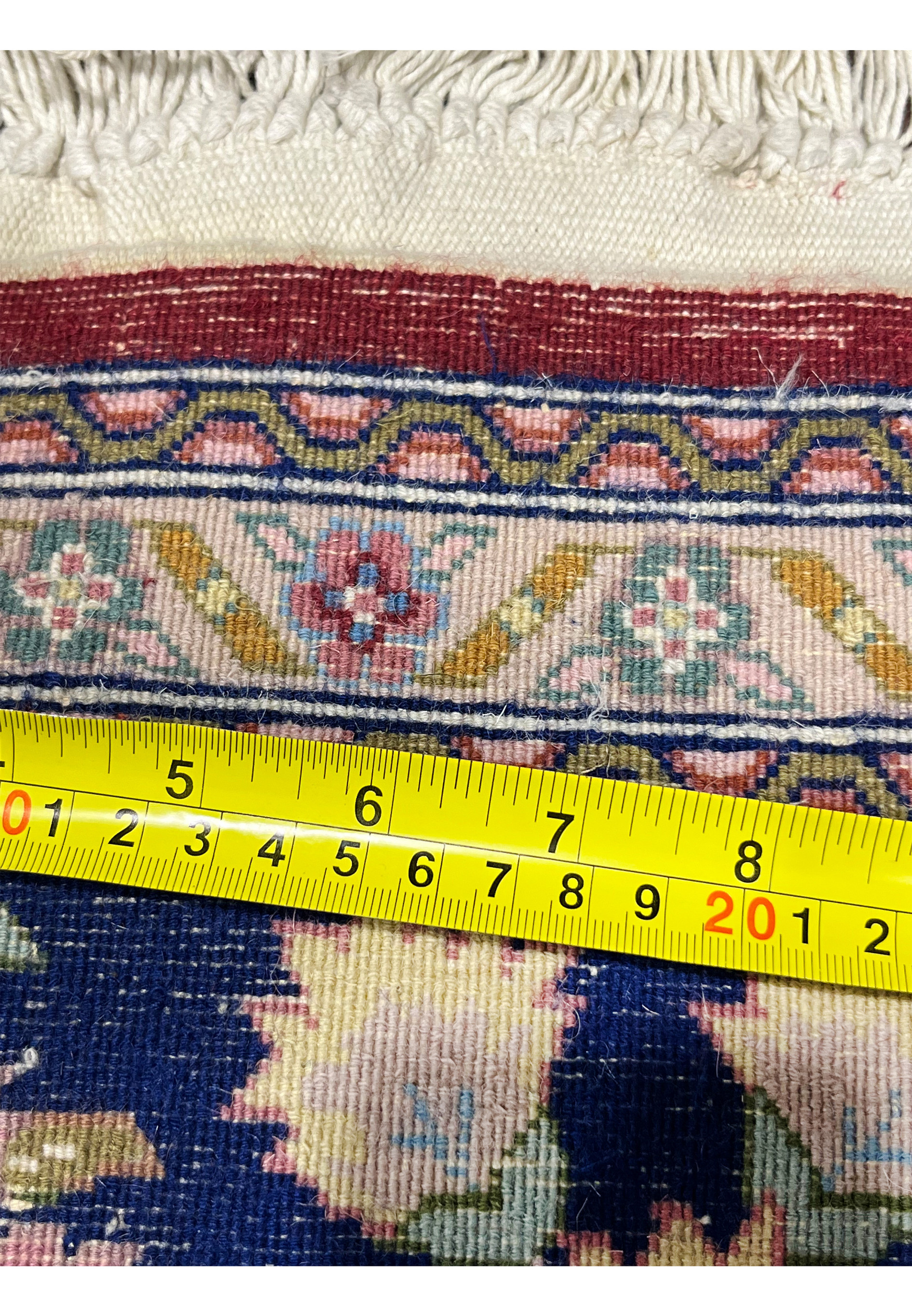 Measured backside of Persian Isfahan rug showing dense knot structure and hand knotted construction