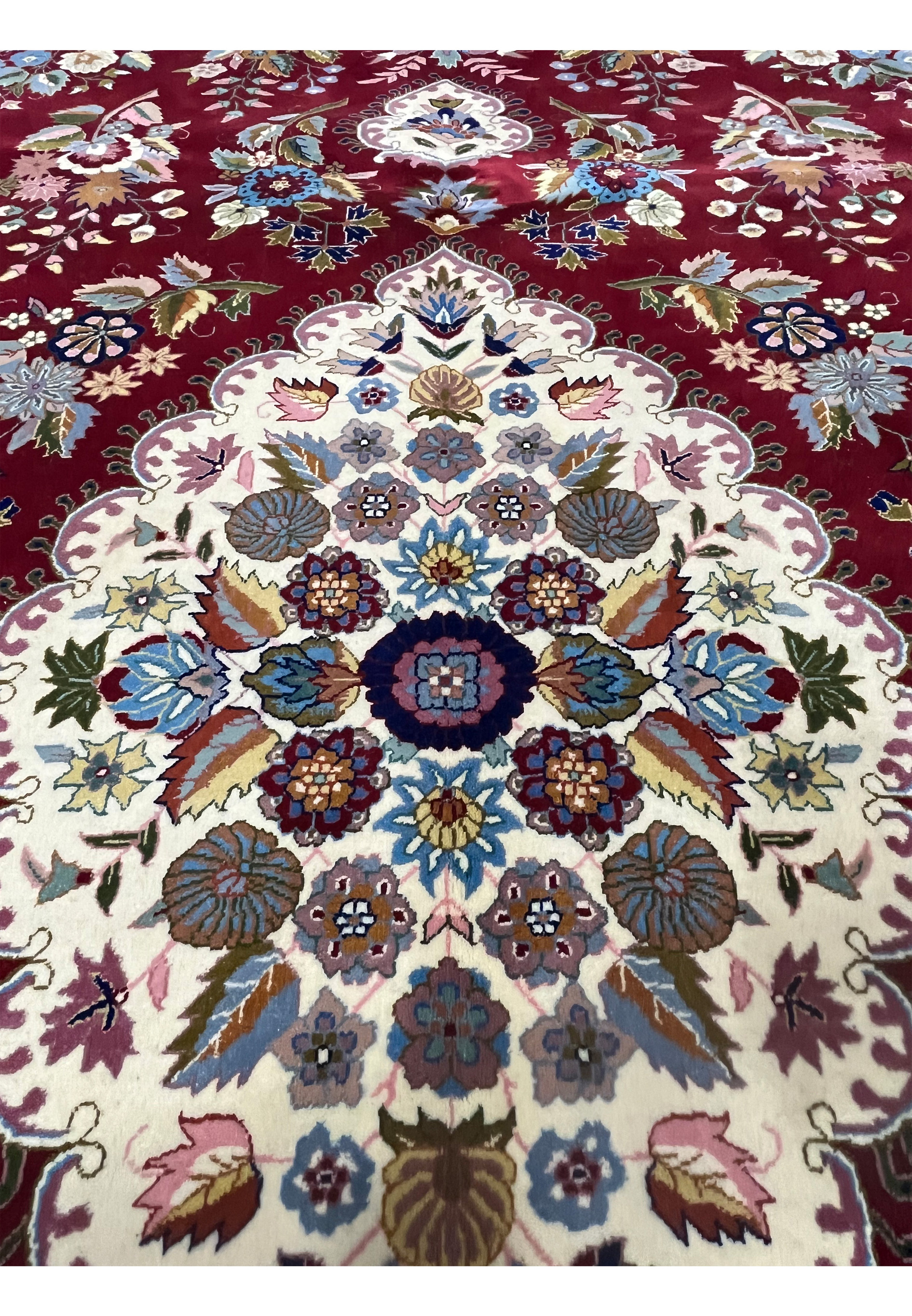 Inner medallion detail of Persian Isfahan rug with symmetrical floral design and silk accents
