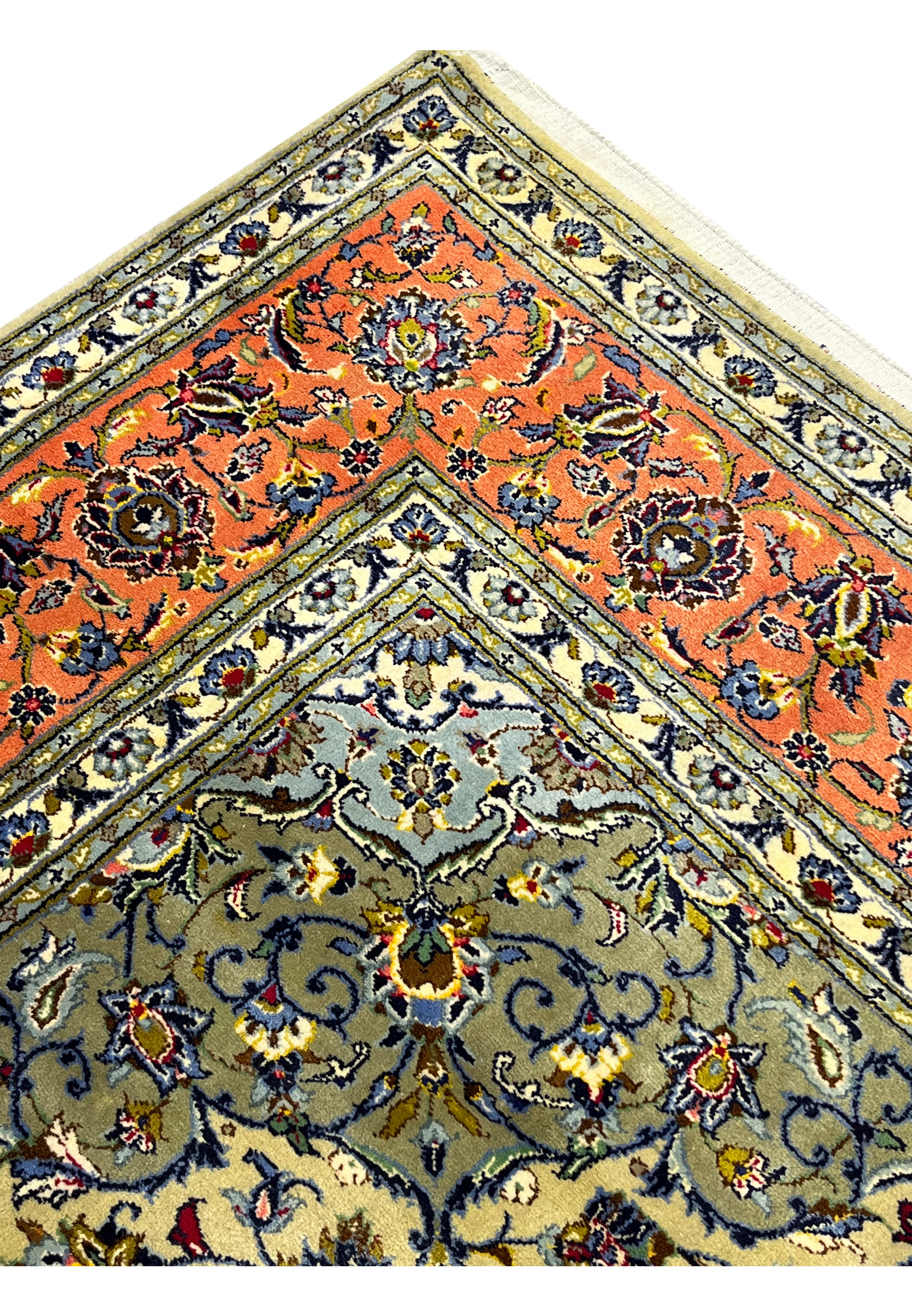 Edge and side finish of green Persian Kashan rug highlighting clean weaving and wool texture