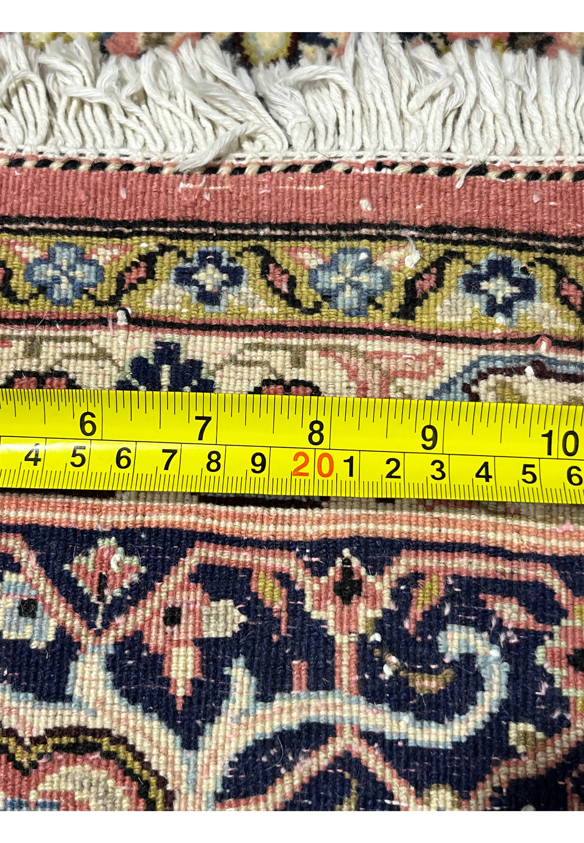 Backside of Persian Bijar rug with ruler demonstrating tight knot scale and heavy iron construction