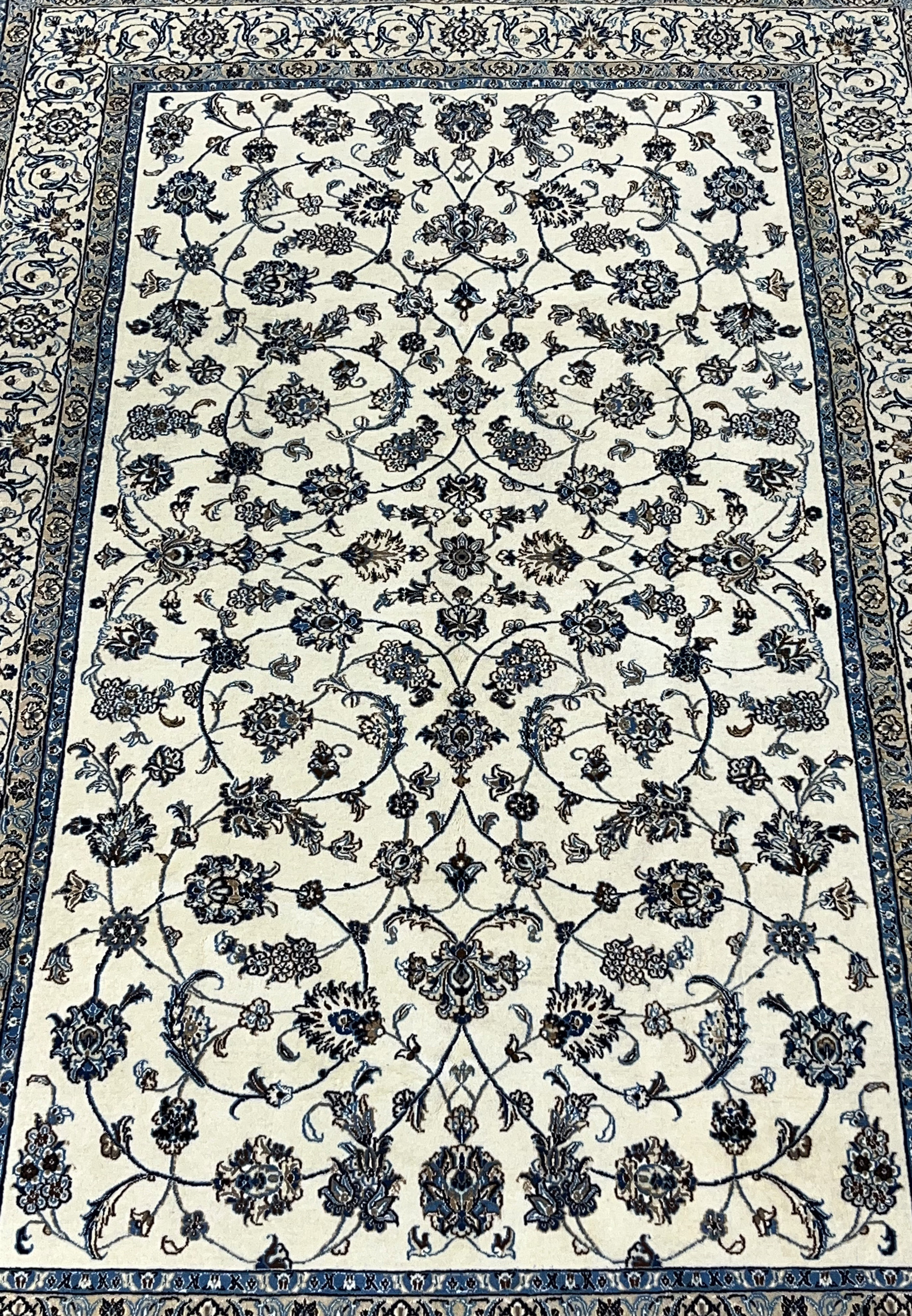 Close view of allover floral field on Persian Nain wool and silk rug