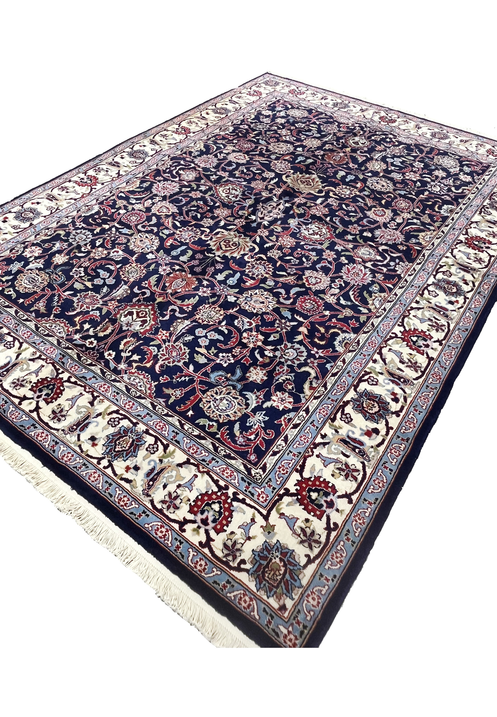 Angled view of a 5'7 x 8 navy blue Persian Sarough kork rug showing dense floral field, ivory border, and deep saturated wool pile