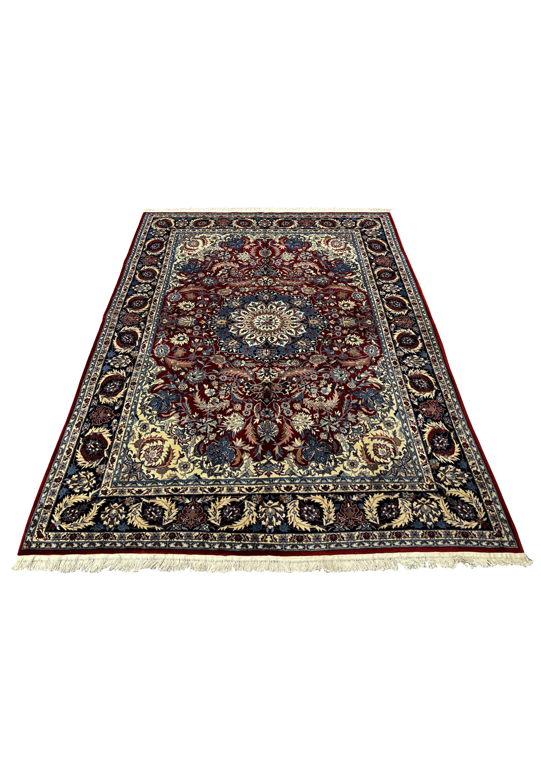 Angled view of burgundy Persian Tabriz rug showing navy border, ivory corners, and centered floral medallion pattern