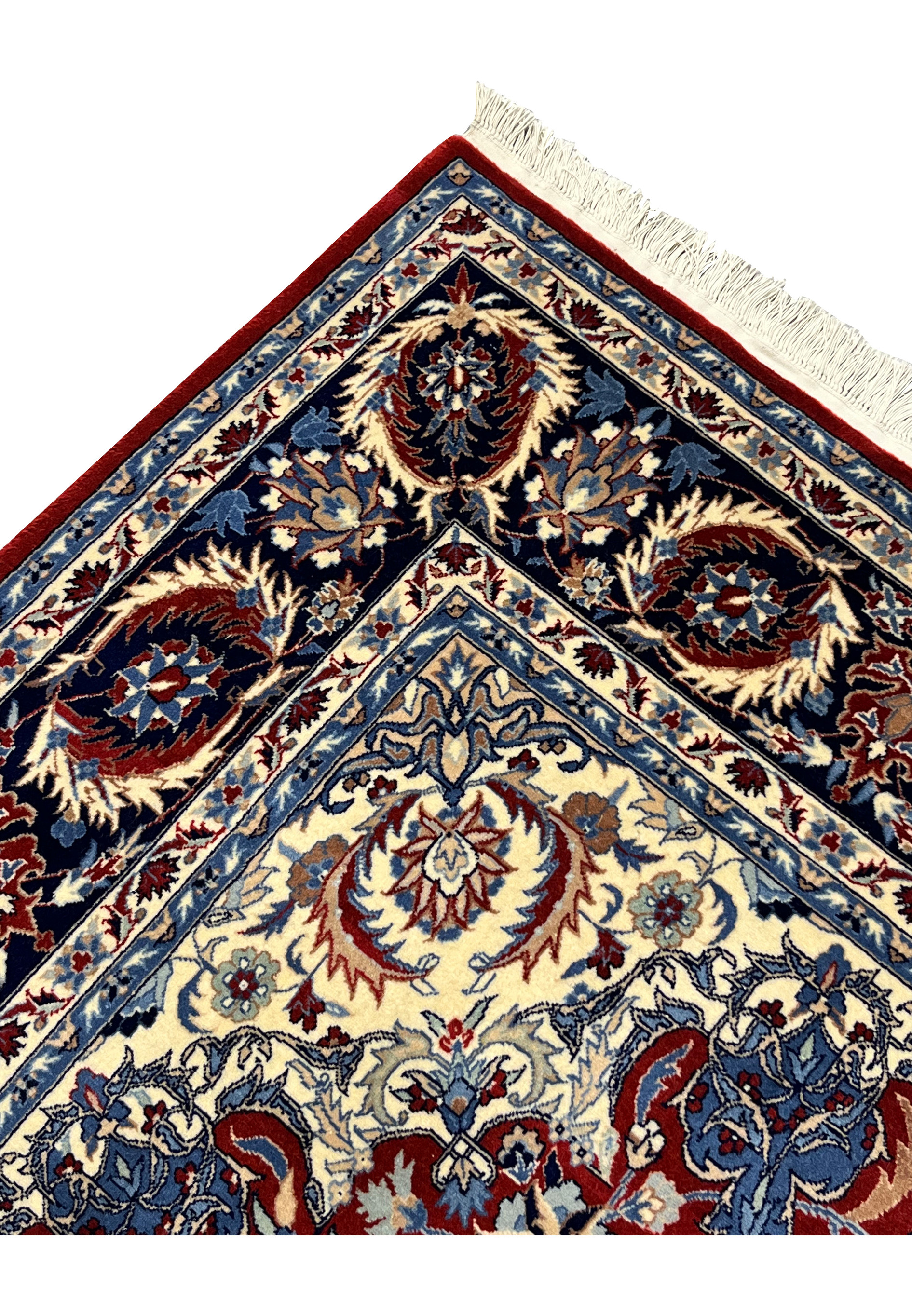 Corner detail of Persian Tabriz rug showing navy border motifs, ivory corner spandrel, and crisp burgundy field pattern