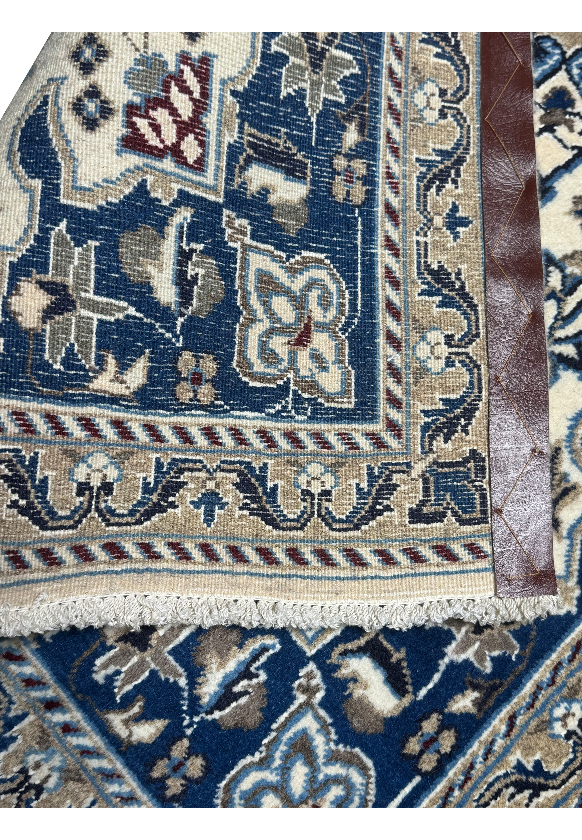 Backside of Persian Nain rug displaying tight weave and cotton foundation