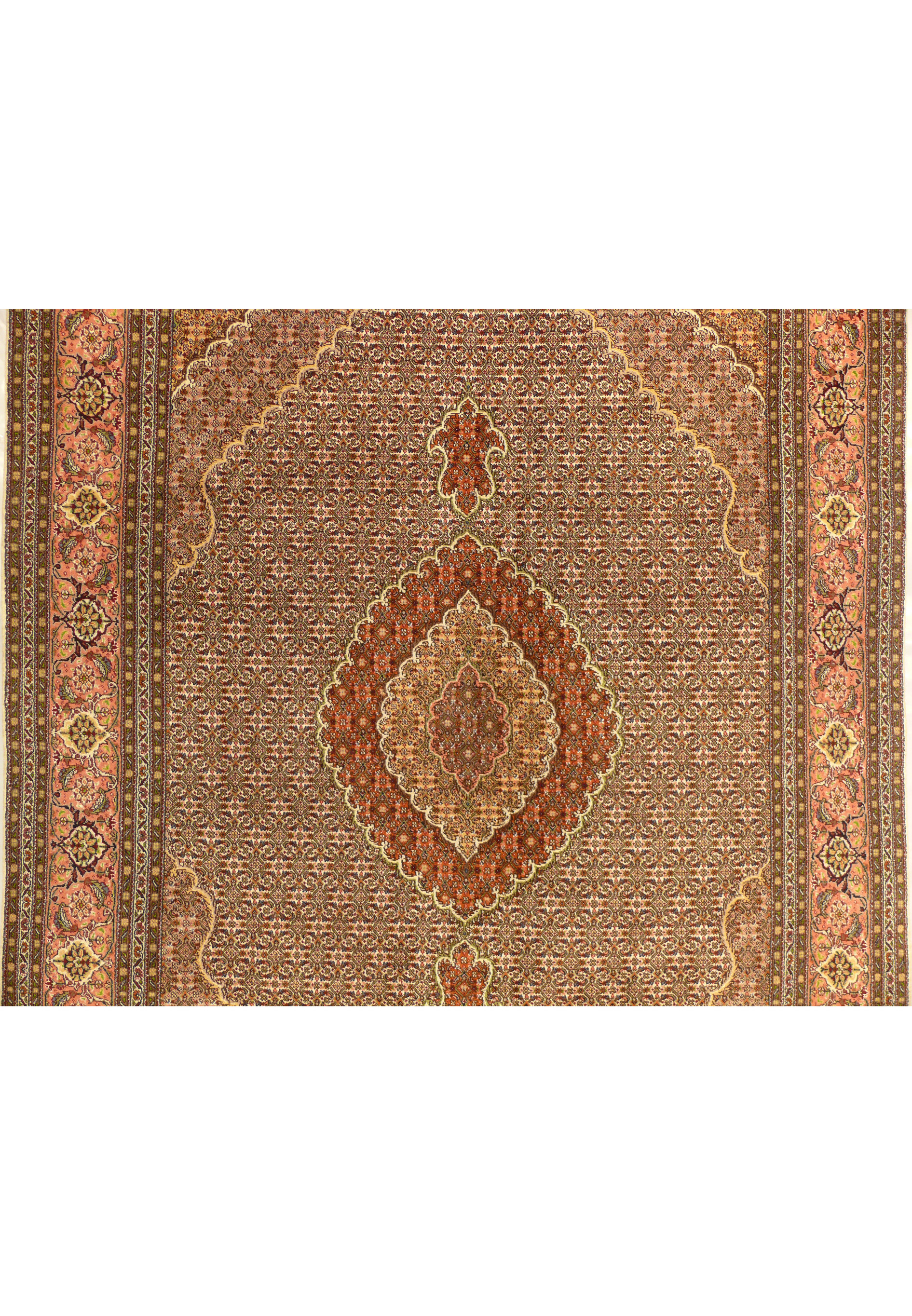 Close up of central medallion on Persian Tabriz Mahi rug with rust and beige detailing