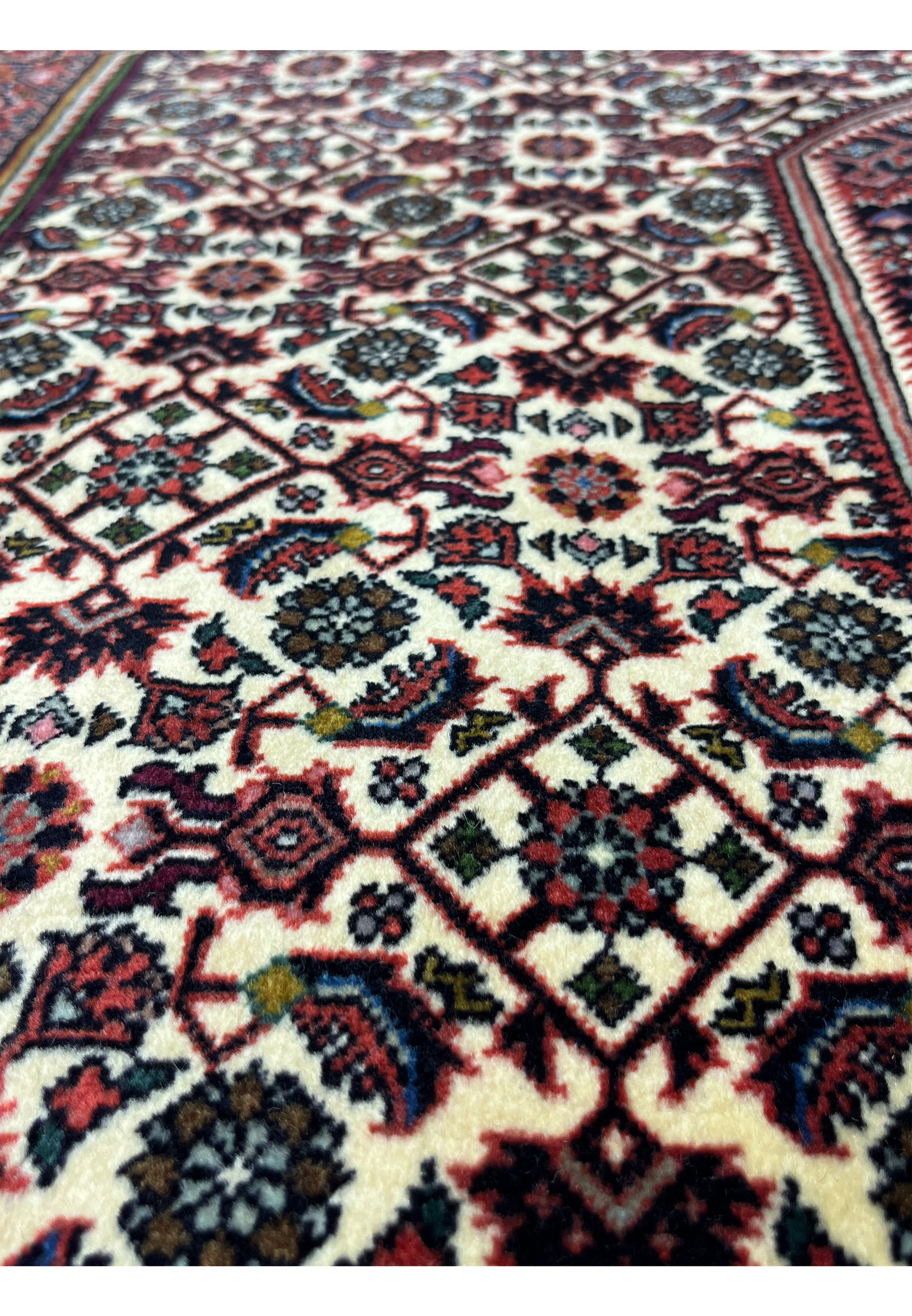 Detailed pattern closeup showing tight knot structure and repeating geometric forms in a Persian Bijar rug