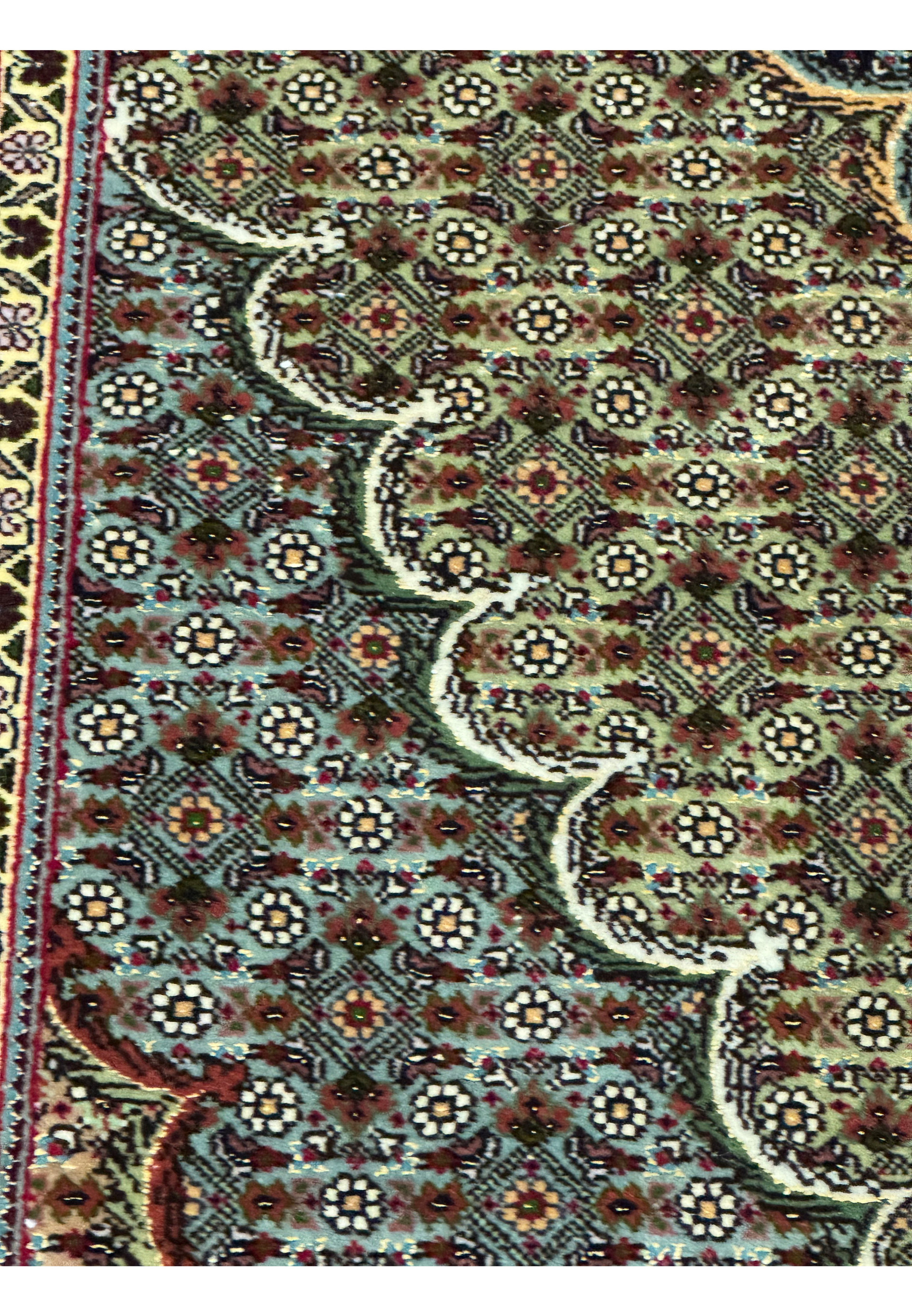 Close up of 11.5 x 16.5 Persian Tabriz Mahi 50 Raj rug showing dense repeating fish pattern with floral rosettes, fine knot structure, deep navy ground, and ivory detailing
