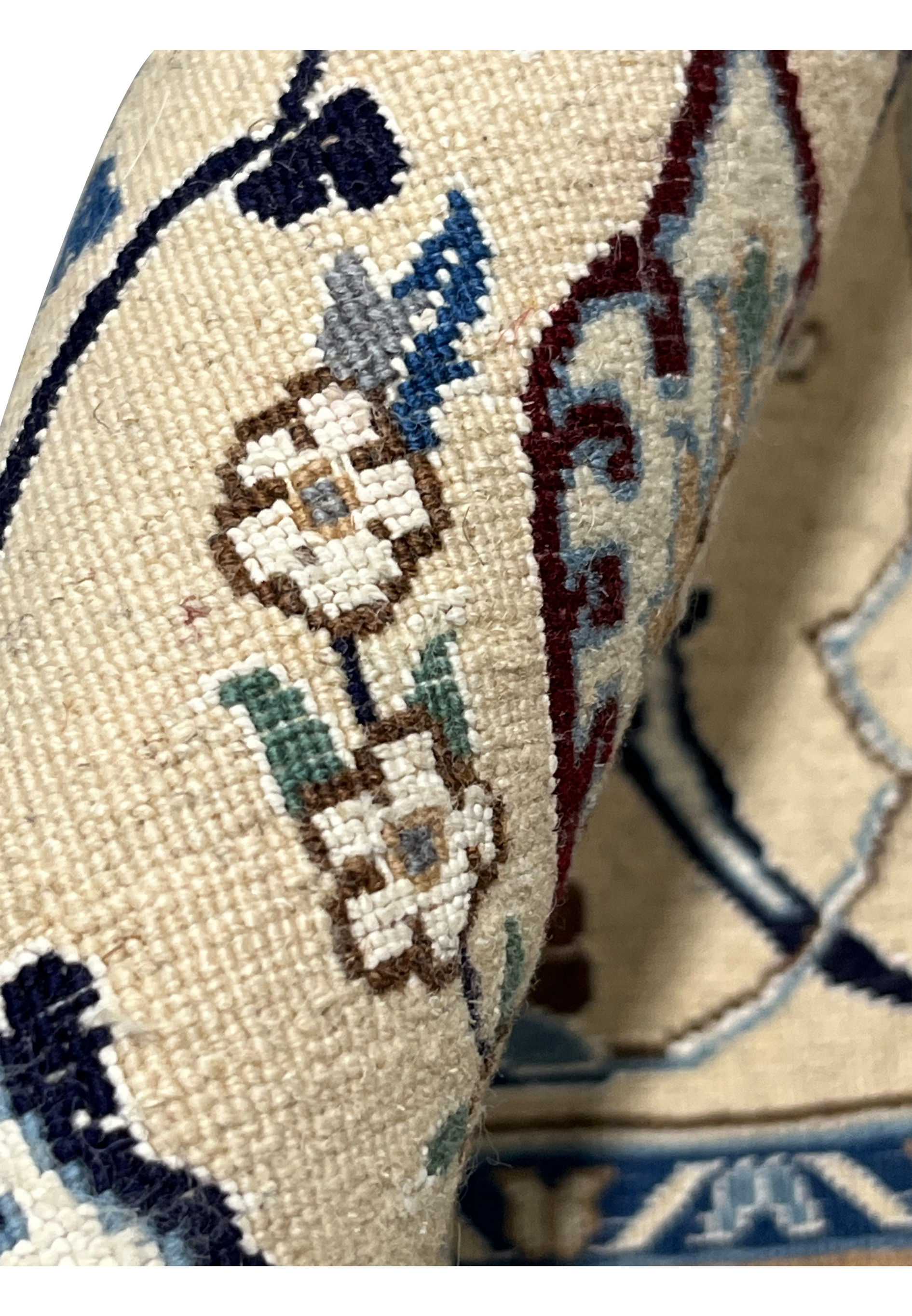 Knot close-up on the backside of a Persian Nain 6 LA rug highlighting dense knot count, fine yarns, silk accents, and expert Iranian weaving