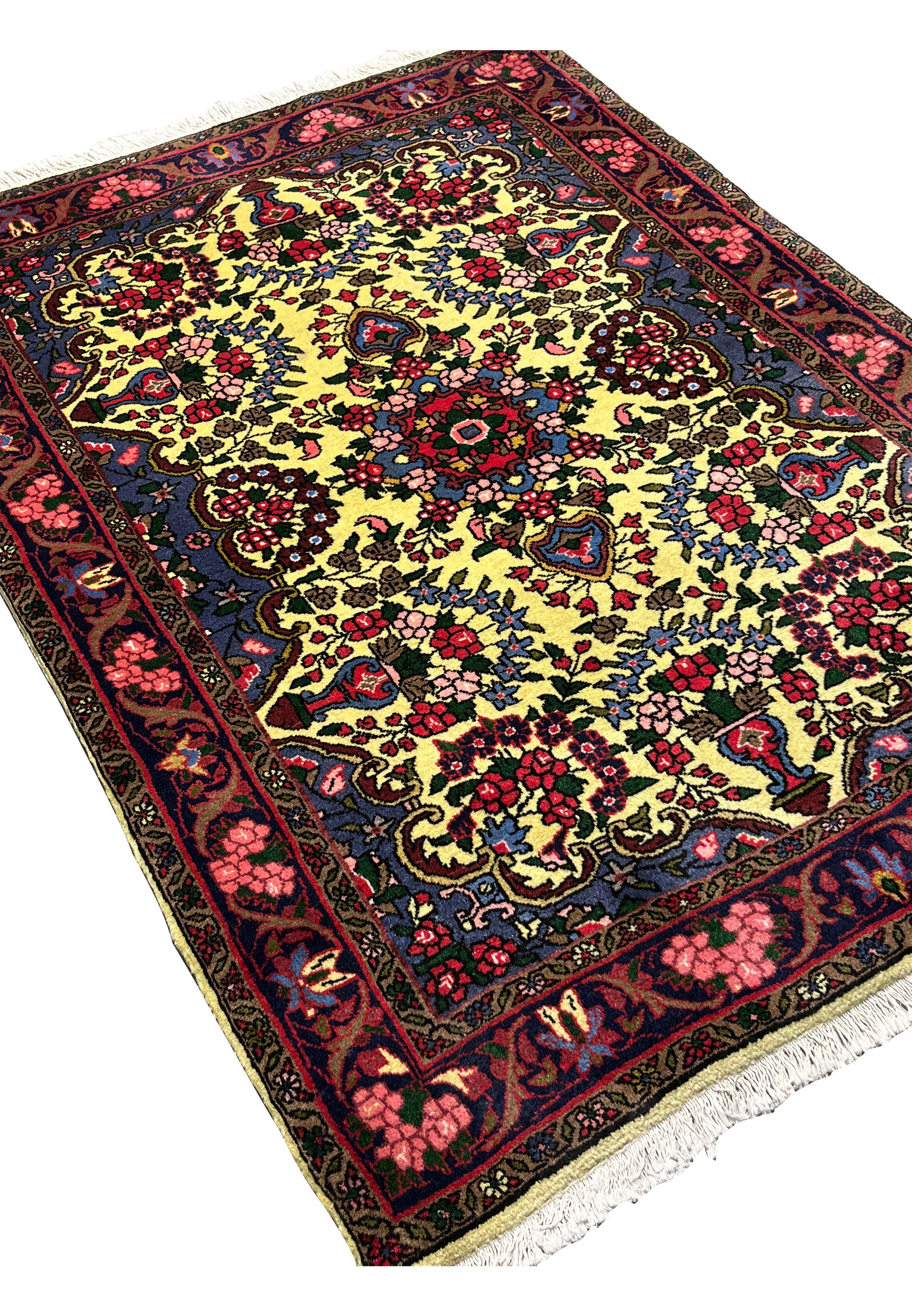 Angled view of Persian Bijar floral rug emphasizing heavy construction, deep red borders, golden field, and durable hand knotted wool surface