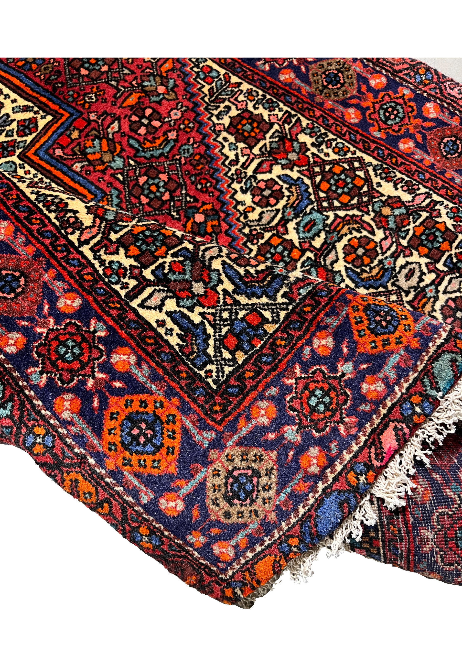 Backside of a Persian Gholtogh rug revealing tight knot structure, even weaving, and craftsmanship quality through visible foundation pattern