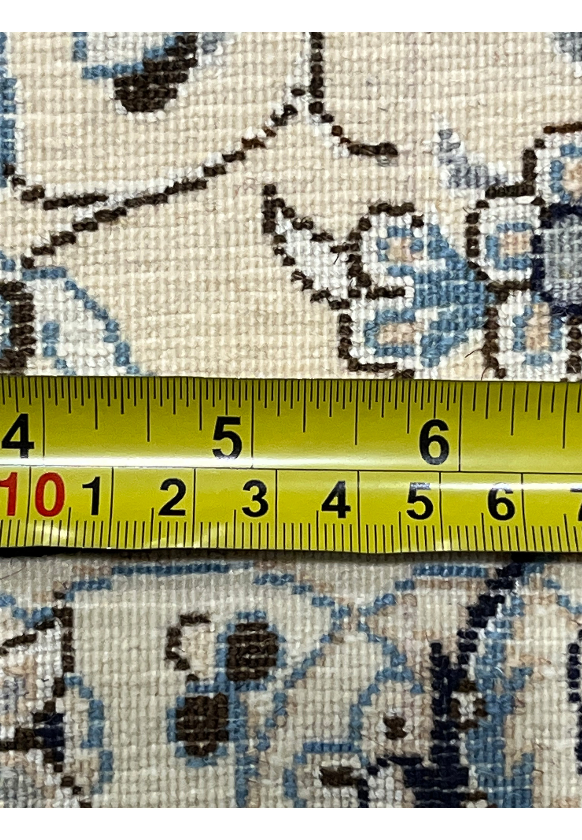 Backside close-up of a 7x10 Persian Nain 6LA Habibian rug showing fine hand-knotted structure, tight weave density, ruler measurement, and precision craftsmanship