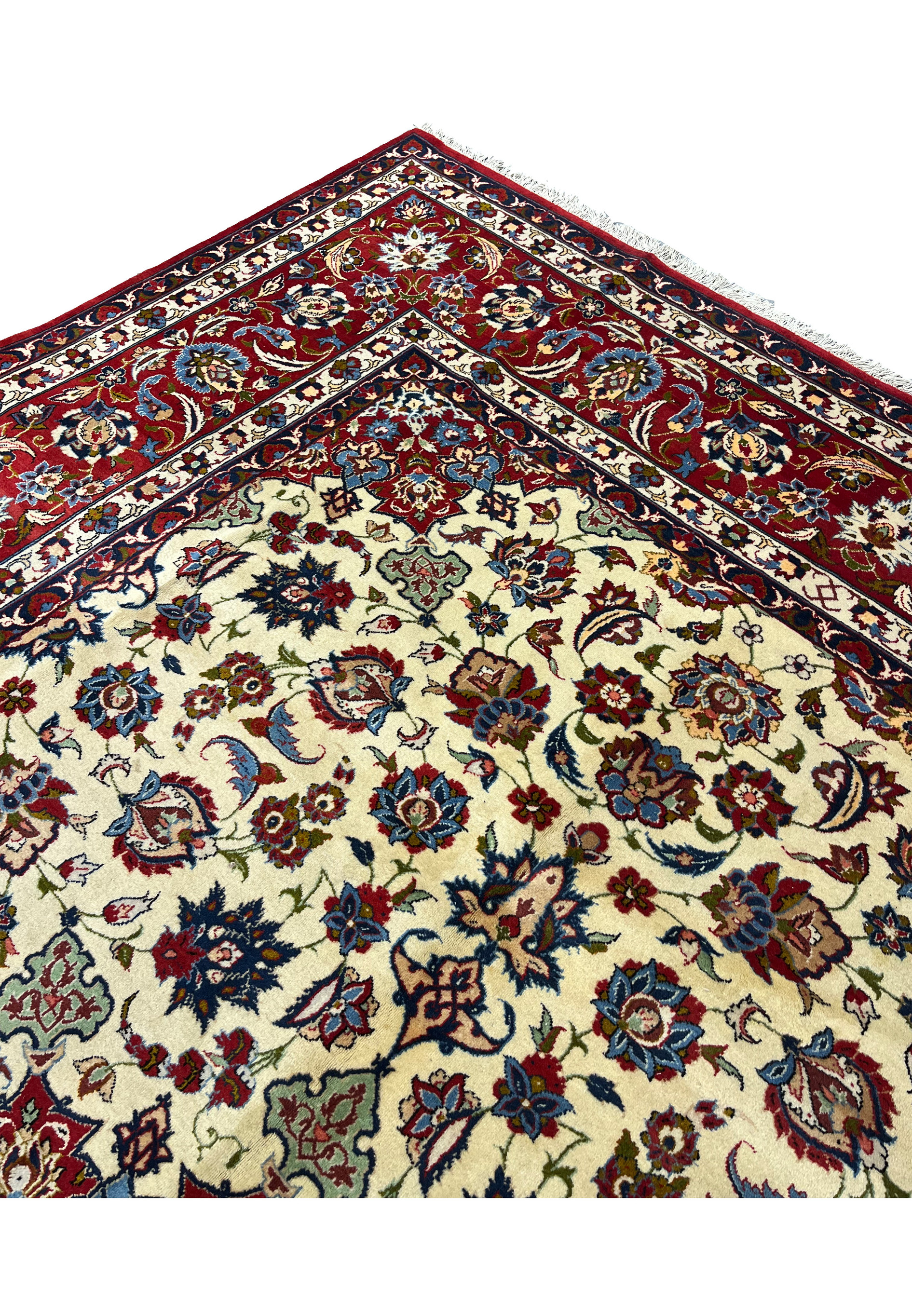 Inner border detail of an Isfahan rug showing layered floral bands, ivory and navy contrast, and fine kork wool craftsmanship with silk detailing.