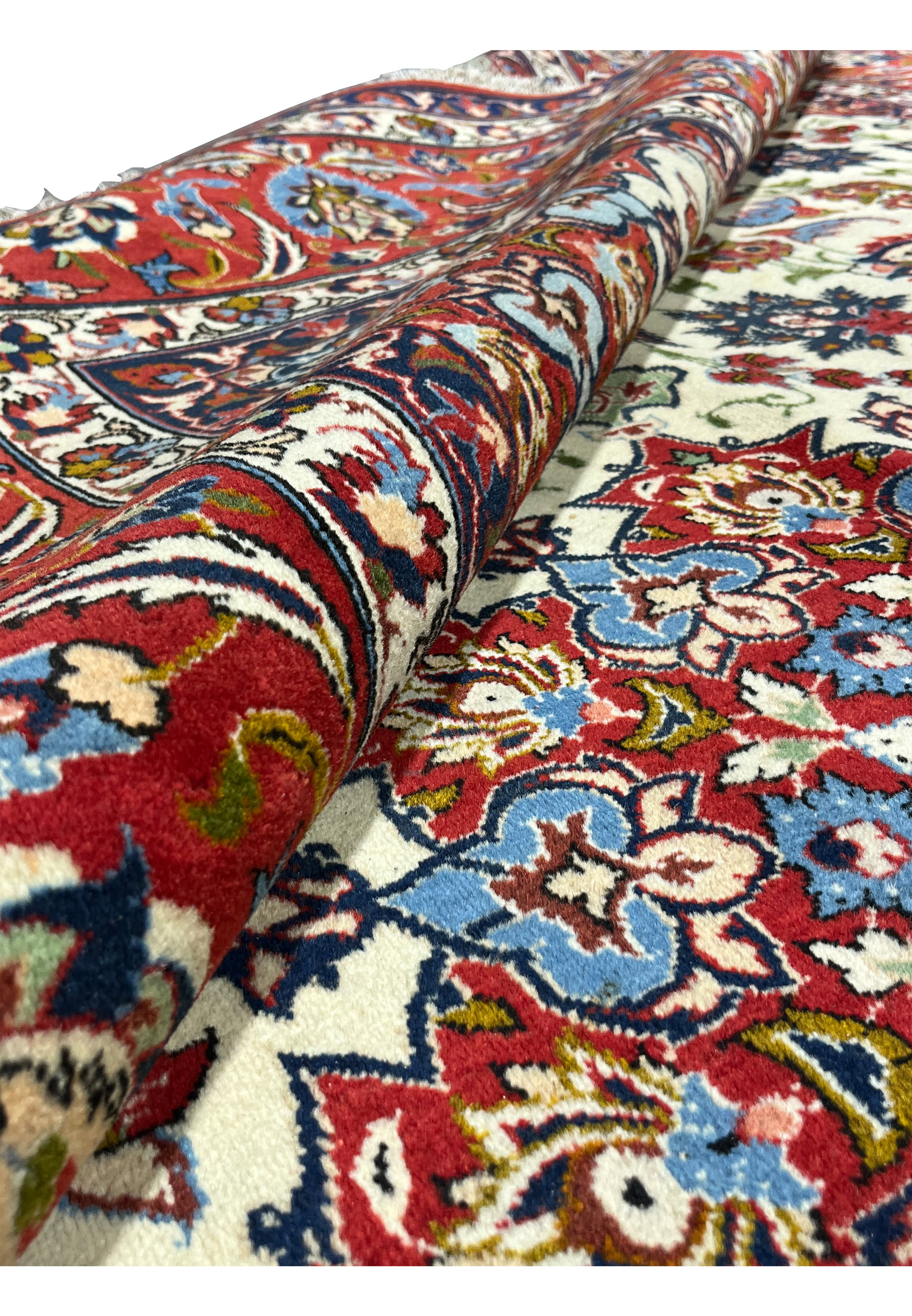 Foundation view of a rolled Isfahan rug showing tightly woven structure, strong warp threads, and durable hand-knotted construction