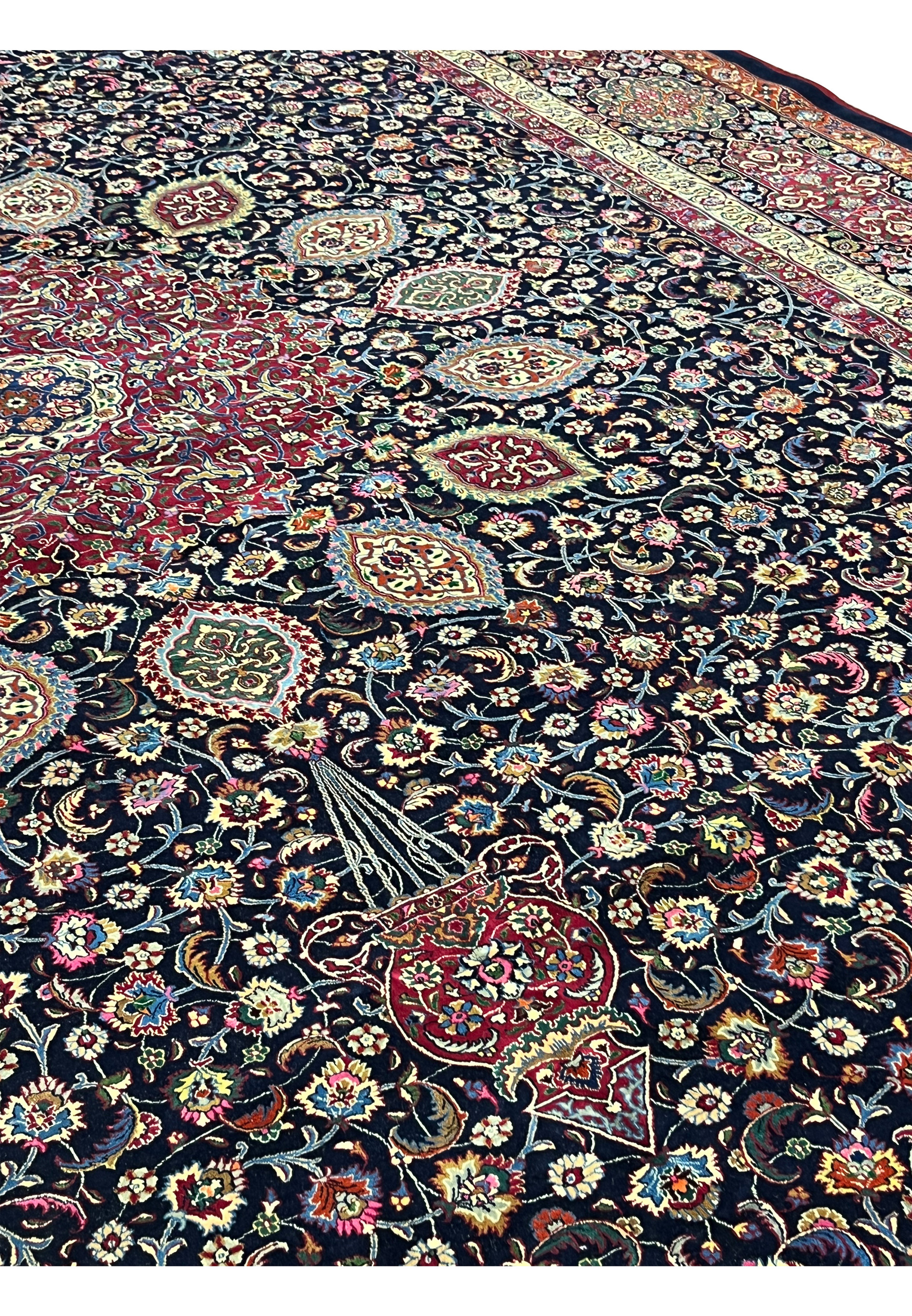 Face close-up of Persian Mashad rug showing tight knot structure, fine kork wool pile, silk accents, and sharply defined floral ornamentation