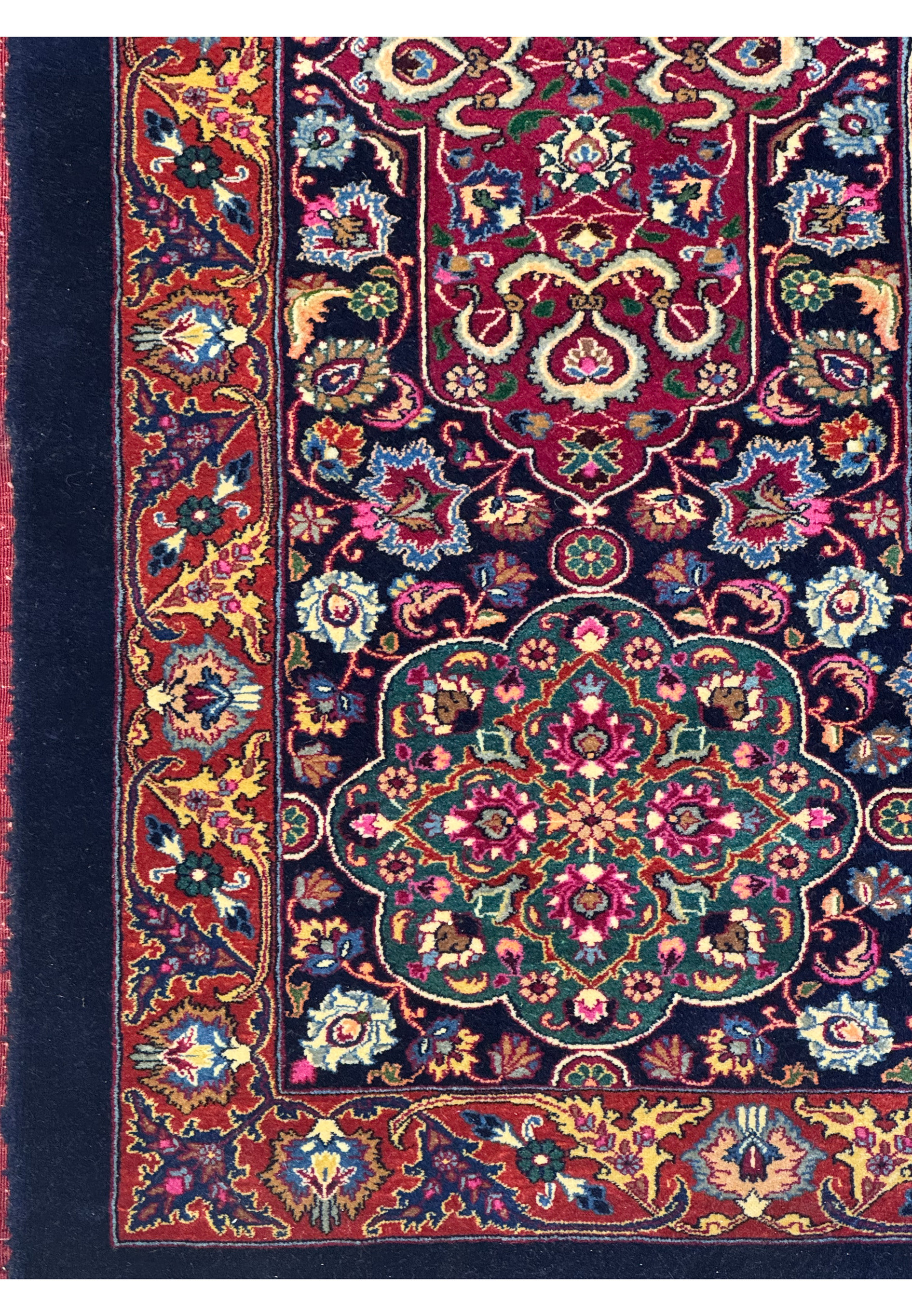 Close-up of floral motifs and scrolling patterns on a Persian Mashad rug, showcasing refined kork wool texture and balanced silk accents.