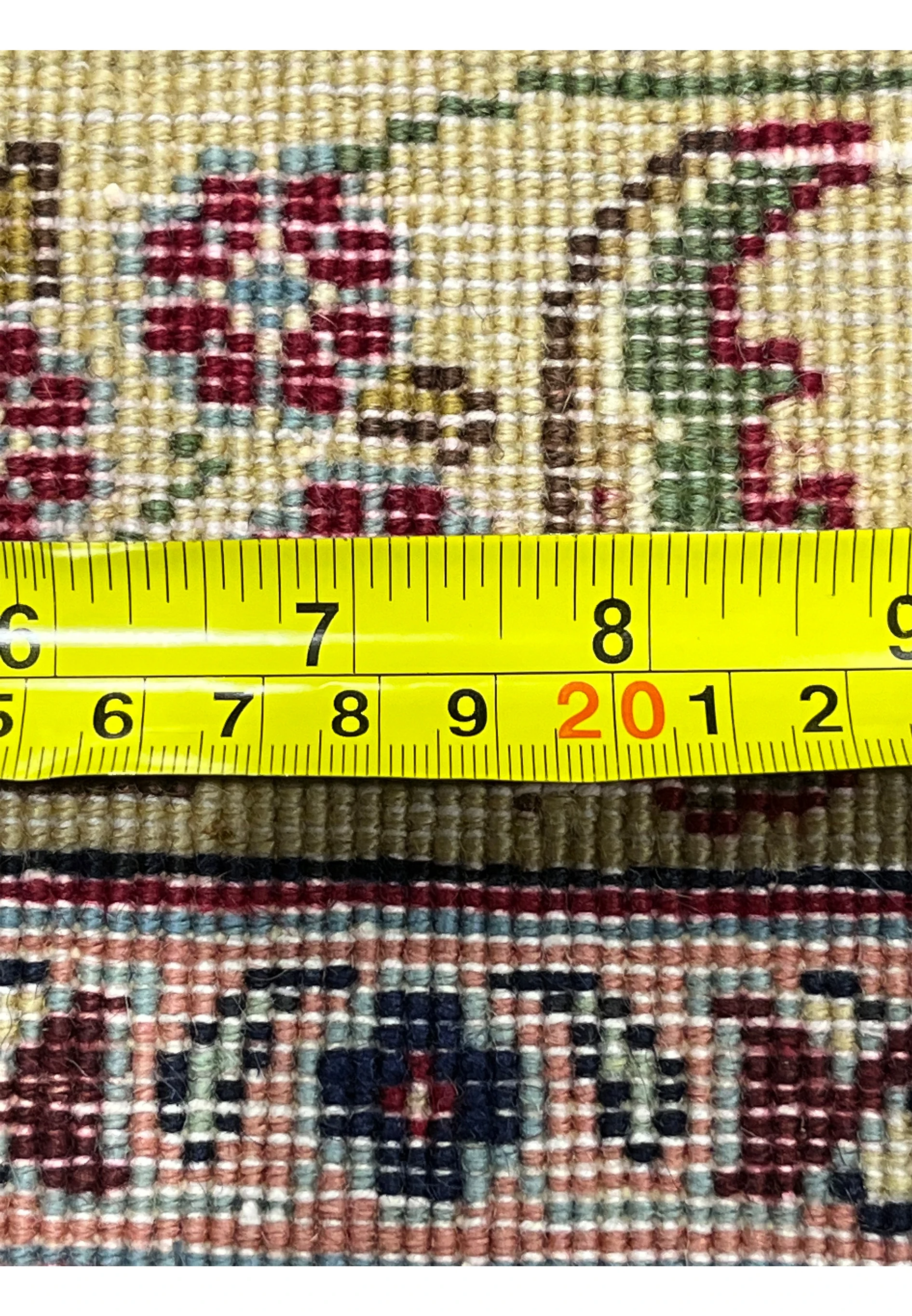 Zoomed backside detail of an 11'2 x 14'4 Persian Tabriz rug with ruler measuring knot density, showing fine weave and detailed craftsmanship